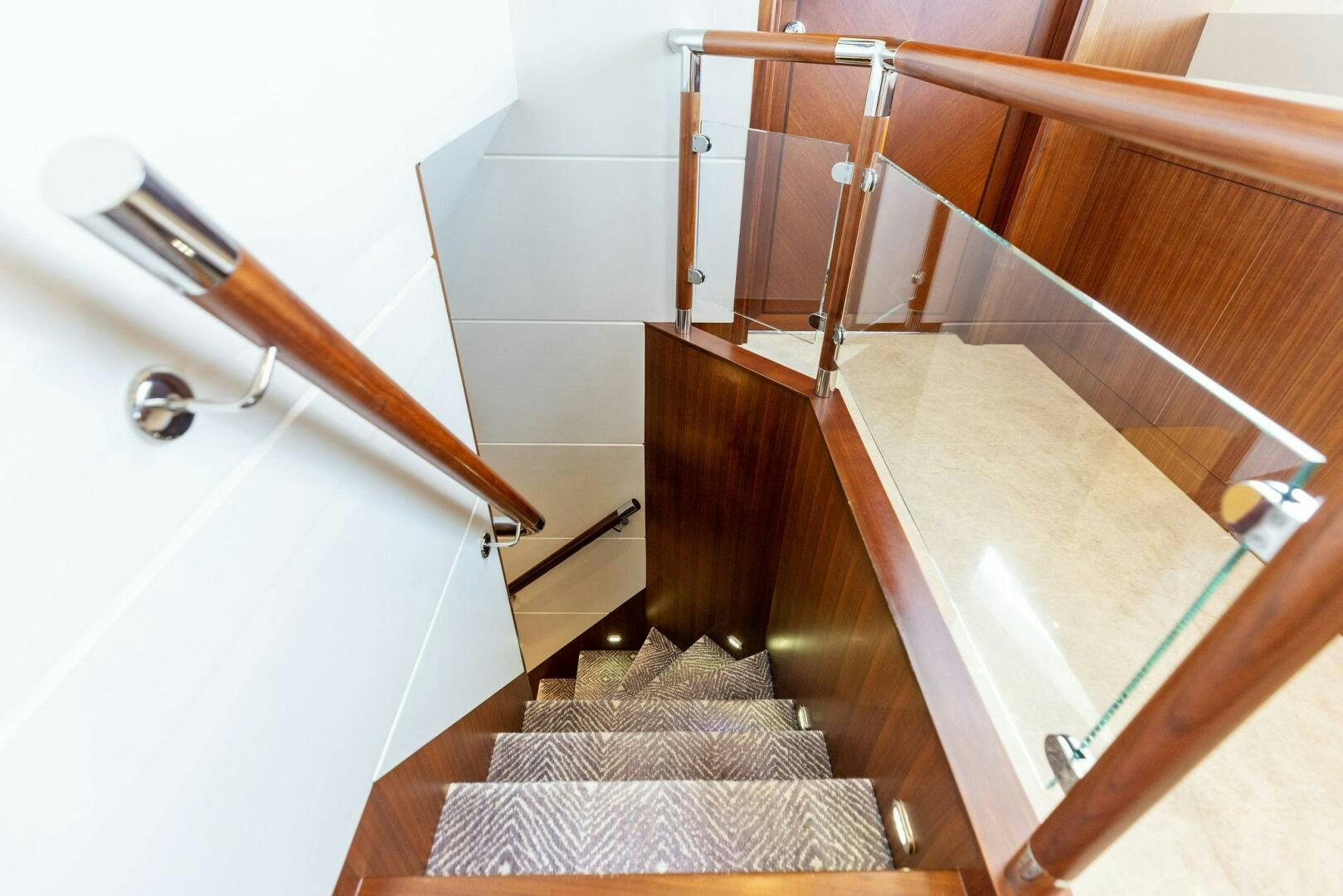 a bathroom with a tub and wooden stairs aboard SUNZSET Yacht for Sale