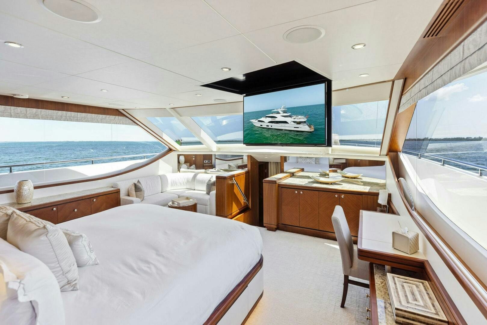 a room with a bed and a tv on the wall aboard SUNZSET Yacht for Sale