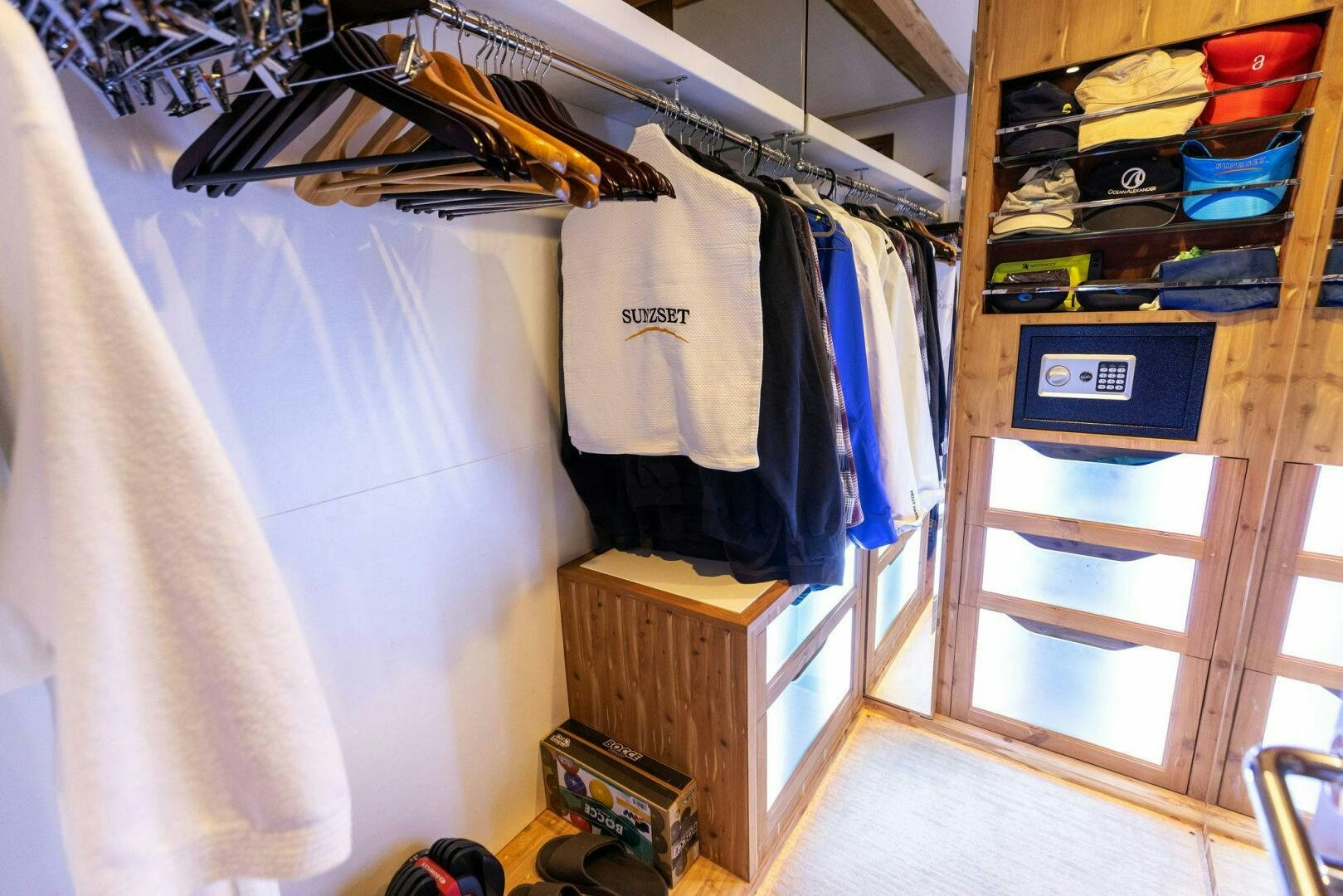 a closet with clothes and shoes aboard SUNZSET Yacht for Sale