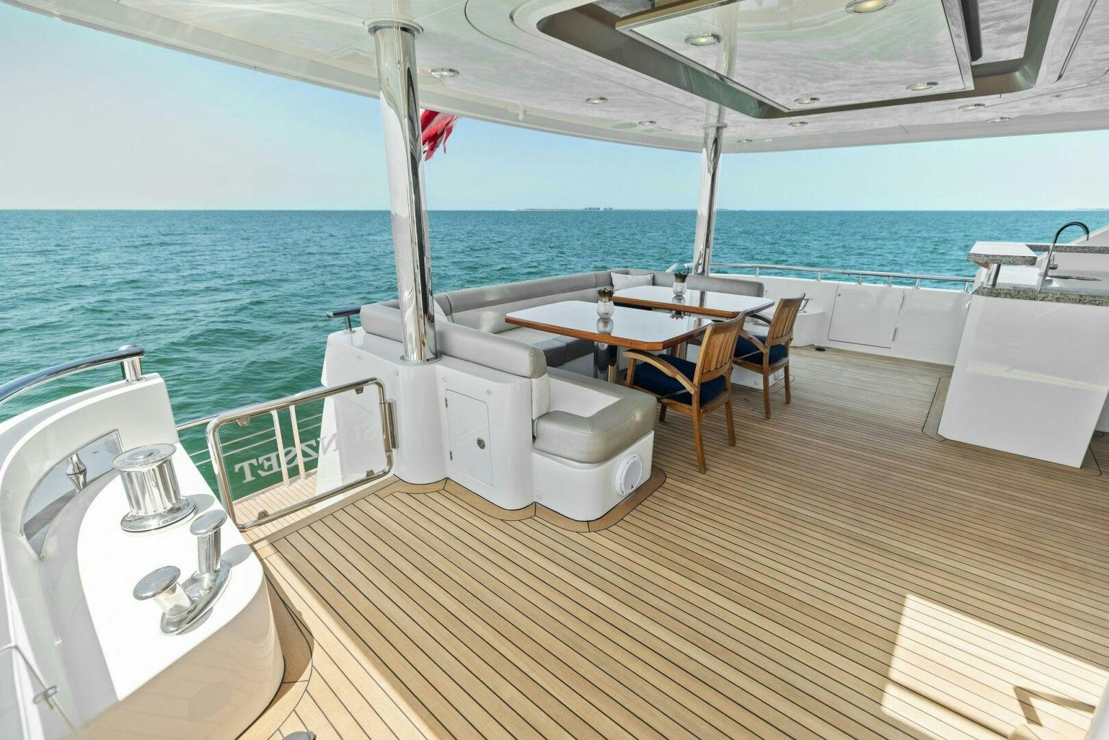 a deck with a sink and a table on it aboard SUNZSET Yacht for Sale