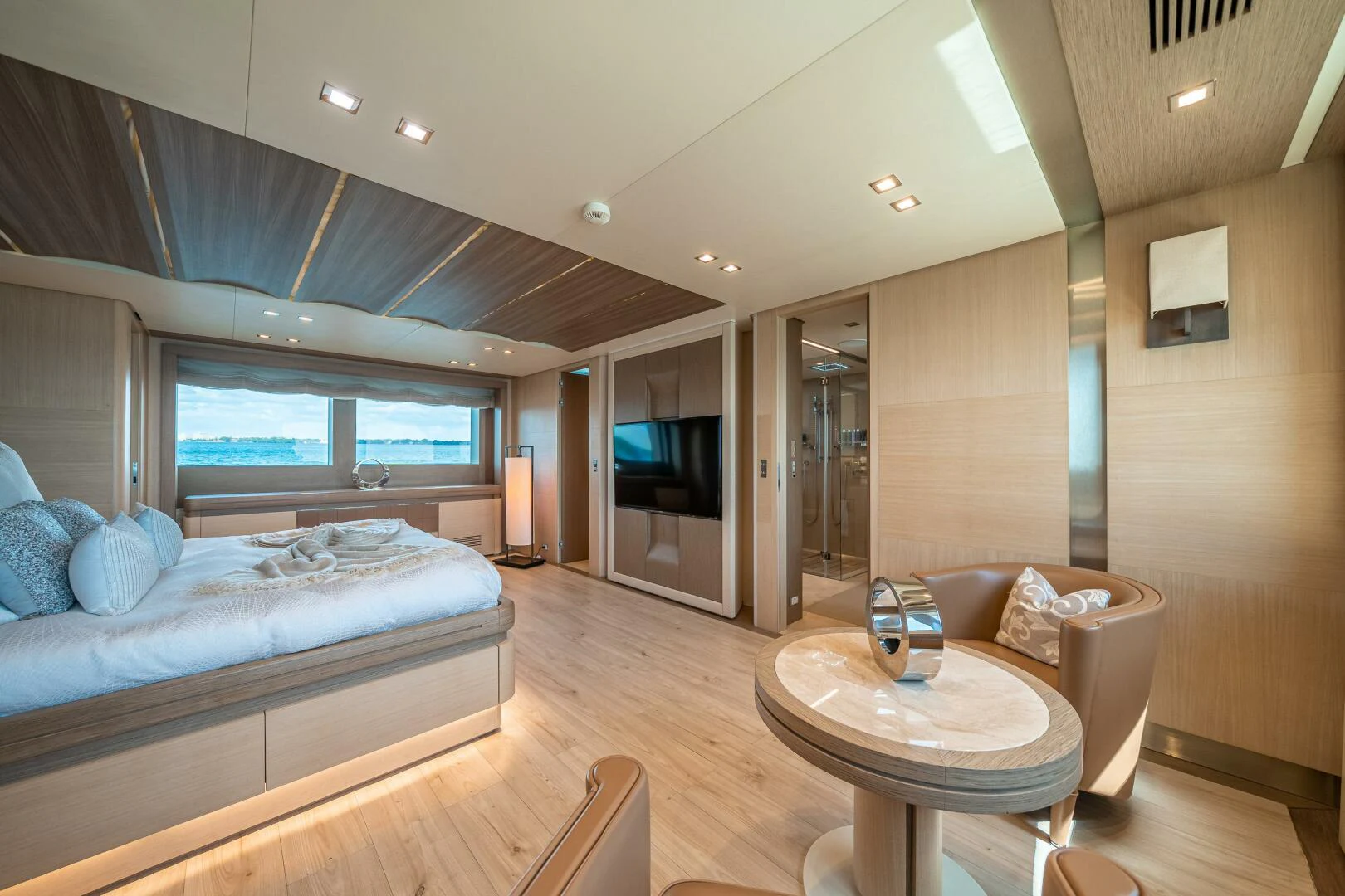 a bedroom with a bed and a table aboard LEUDIN I Yacht for Sale