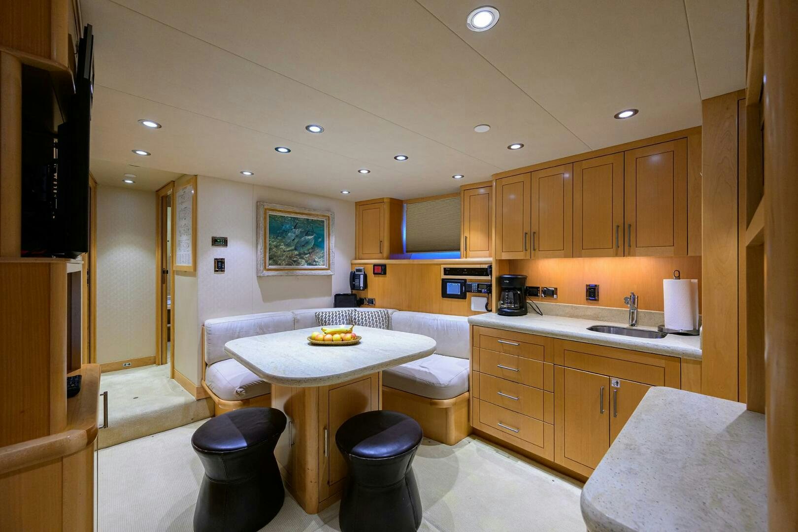 a kitchen with a table and chairs aboard SARABETH Yacht for Sale