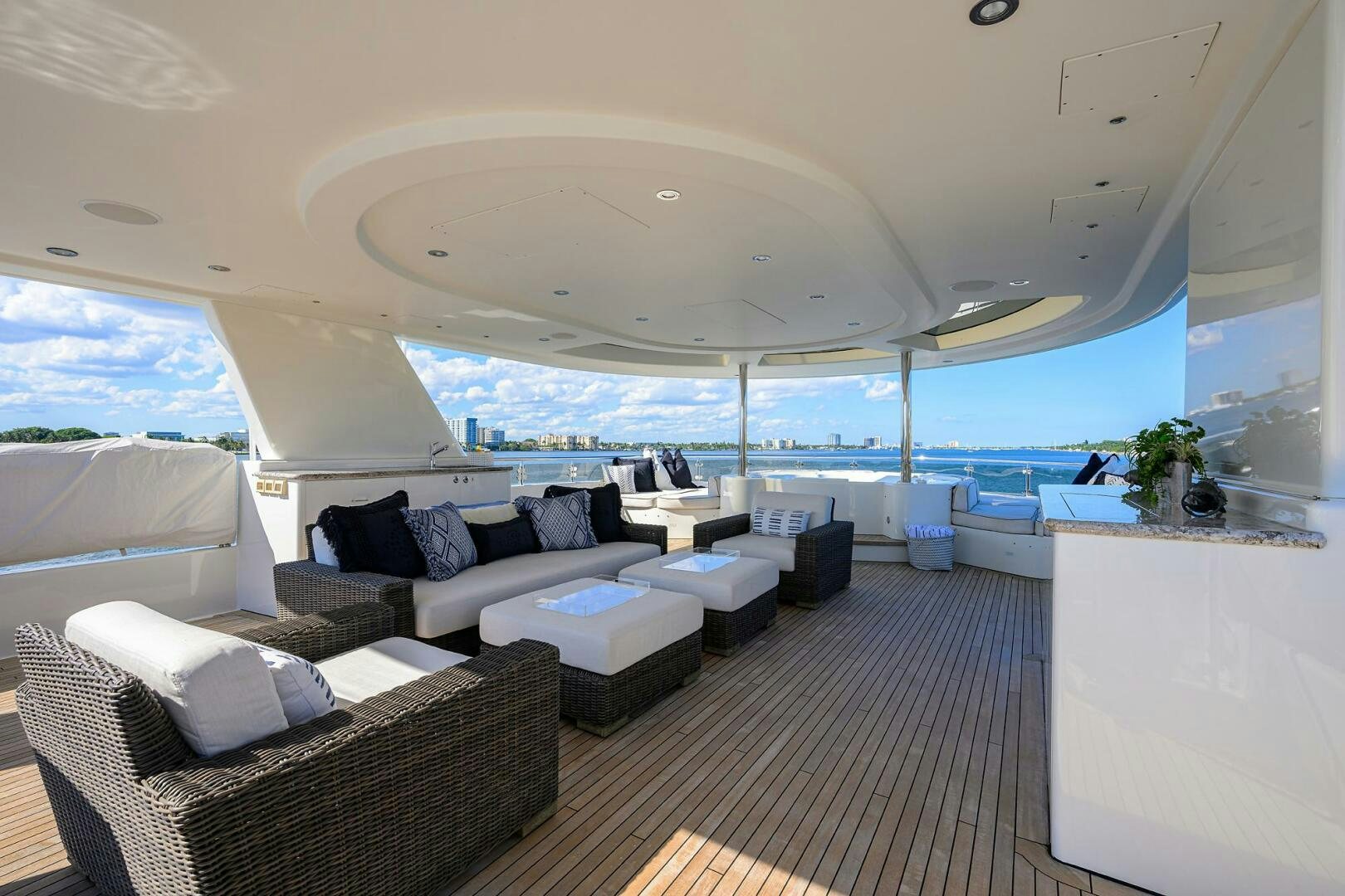 a room with a couch and a table and a large window aboard SARABETH Yacht for Sale