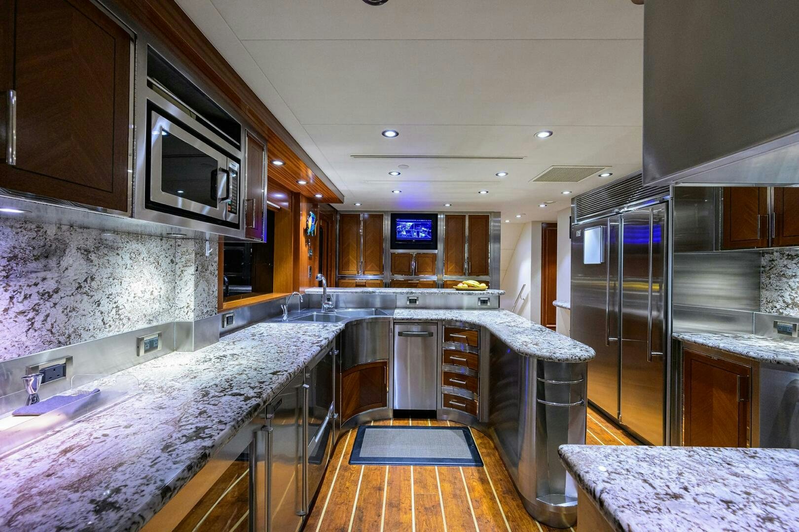 a kitchen with a large bar and bar seating aboard SARABETH Yacht for Sale
