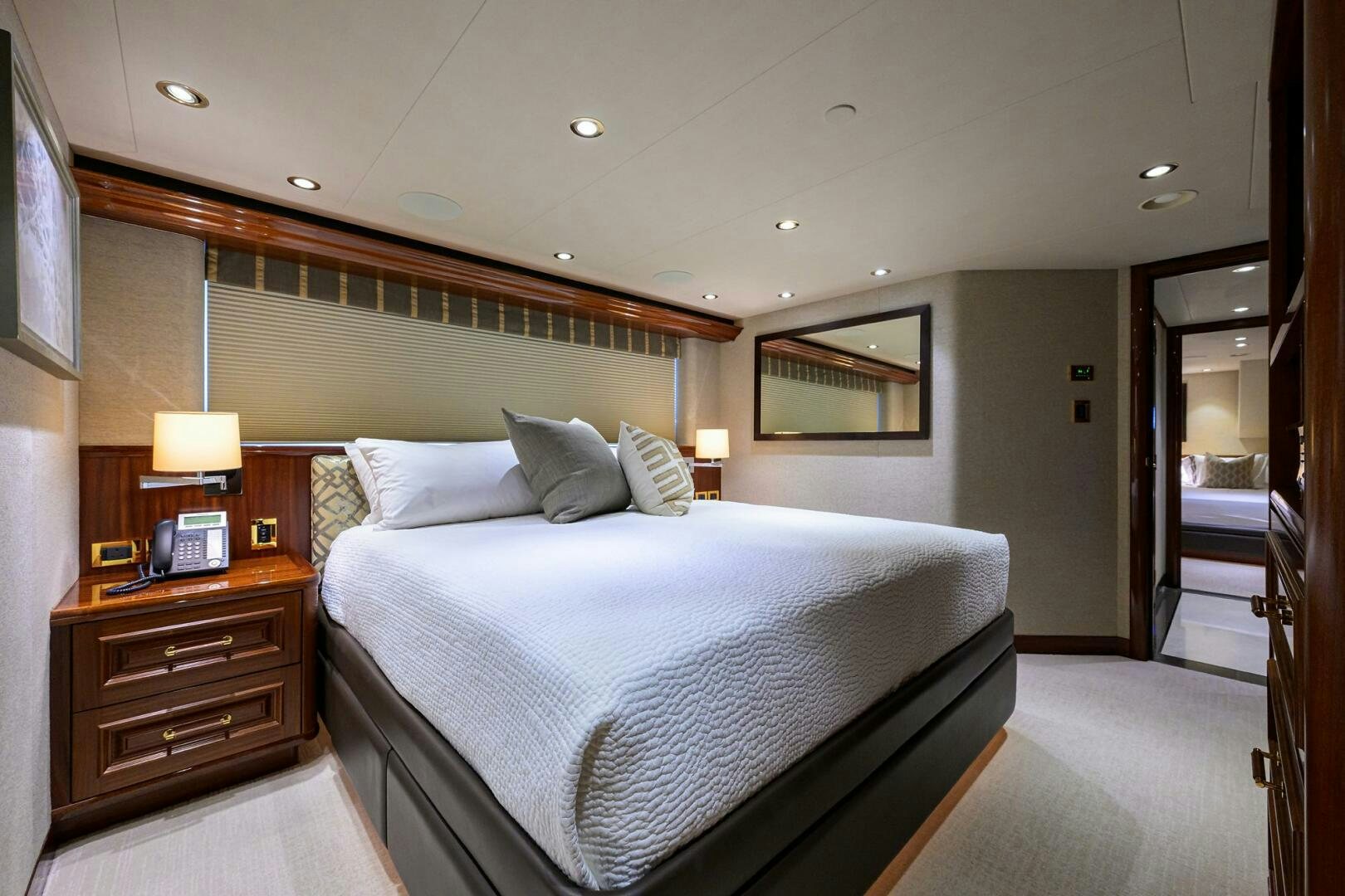 a bedroom with a bed and a desk aboard SARABETH Yacht for Sale