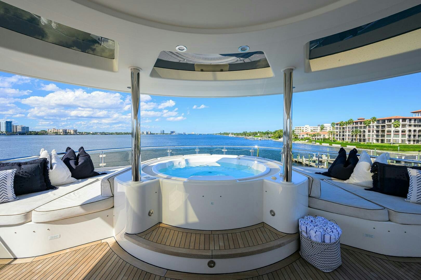 a large white bed with a white canopy and a large white bed on a deck with a view aboard SARABETH Yacht for Sale