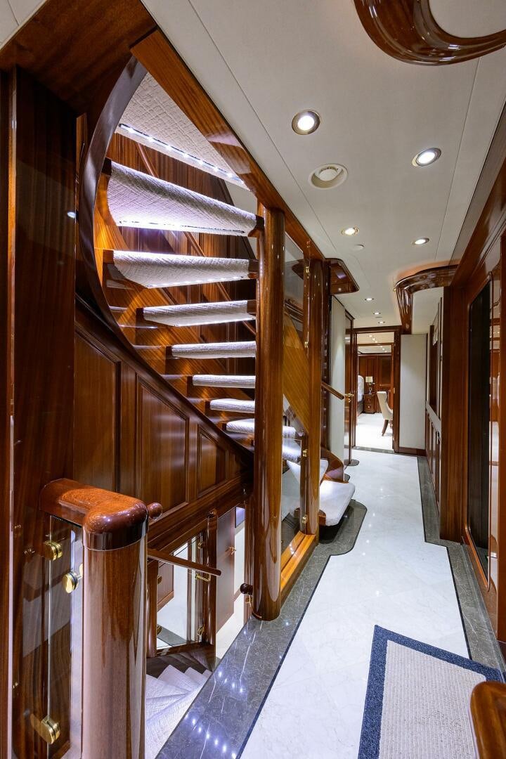 a wood staircase in a house aboard SARABETH Yacht for Sale