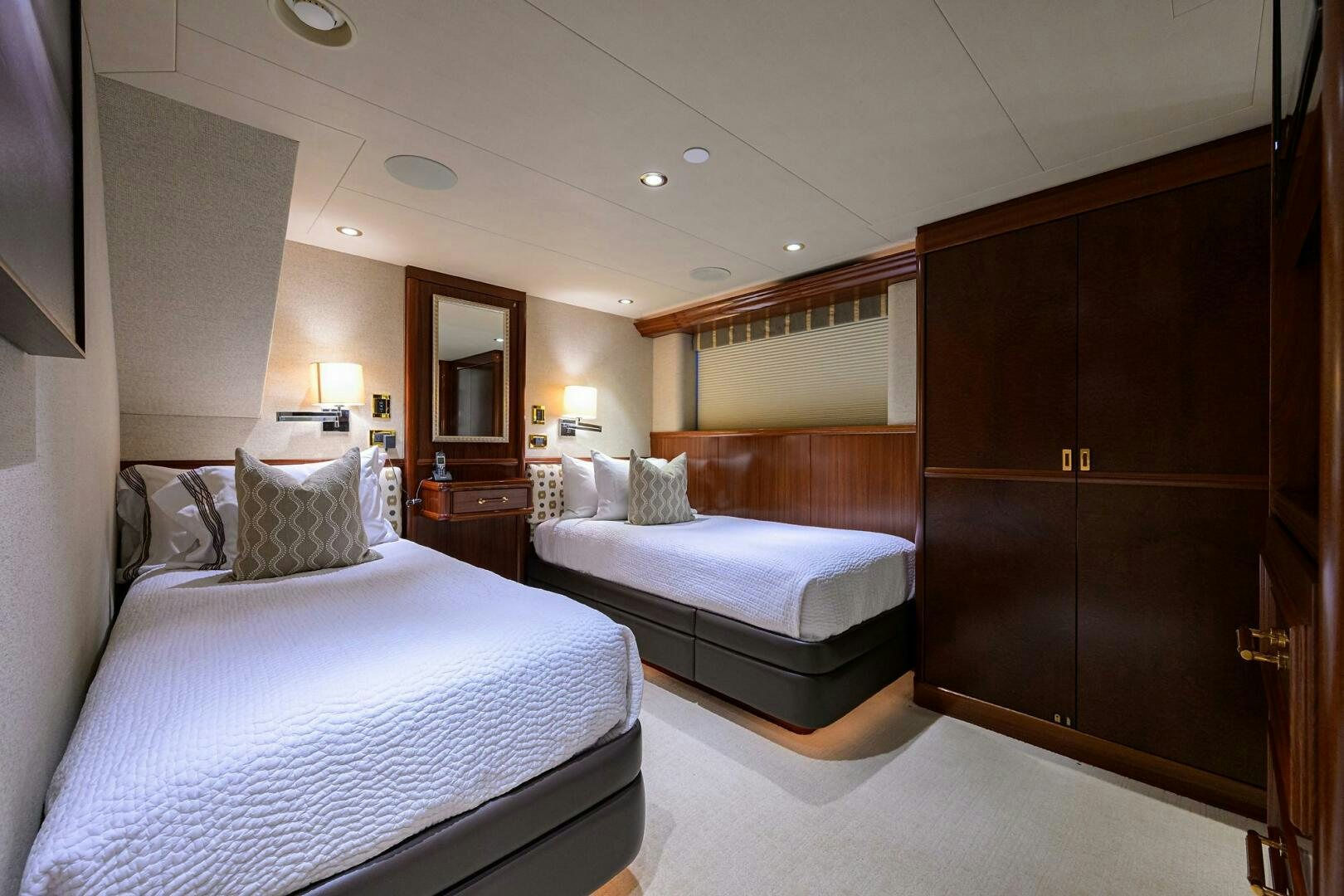 a hotel room with a bed and a mirror aboard SARABETH Yacht for Sale