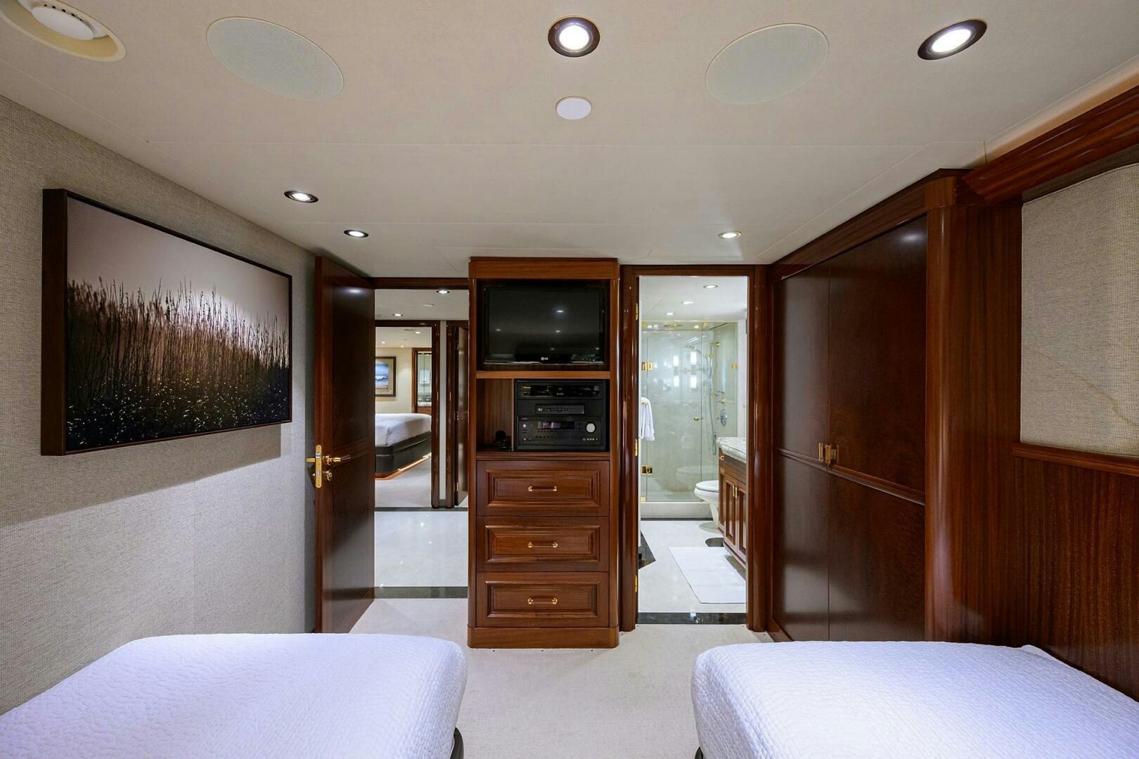 a bedroom with a bed and a television aboard SARABETH Yacht for Sale