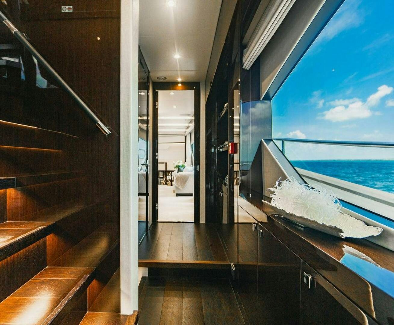 a room with a large window and a view of the ocean aboard PURA VIDA Yacht for Sale
