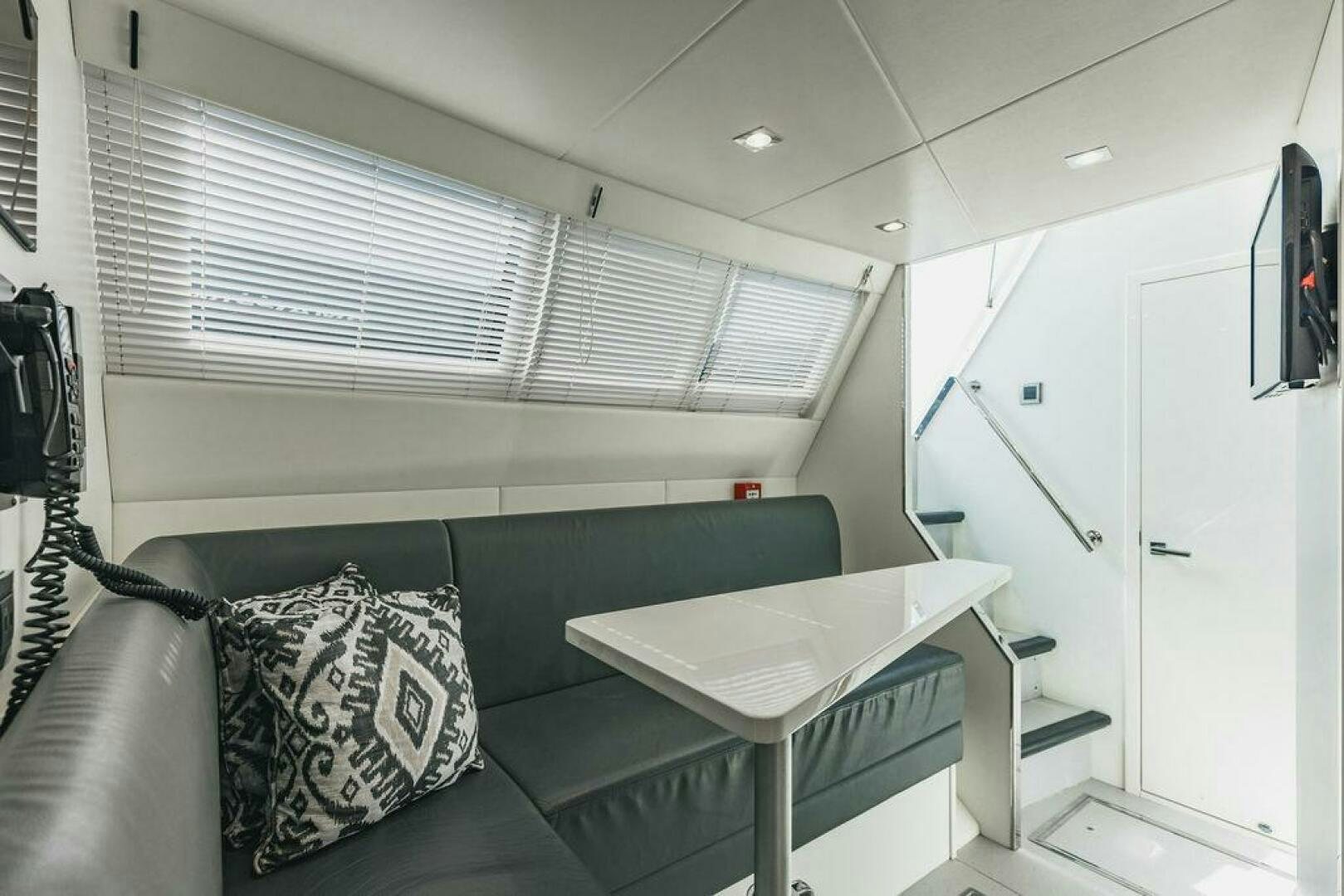 a room with a couch and a table aboard PURA VIDA Yacht for Sale