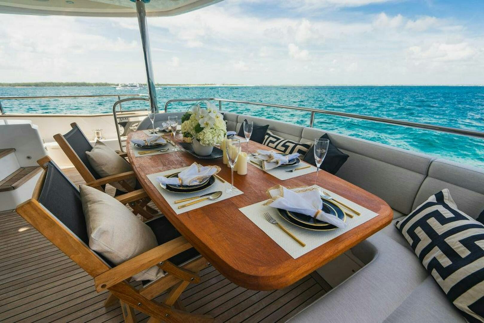 a table with plates and food on it aboard PURA VIDA Yacht for Sale