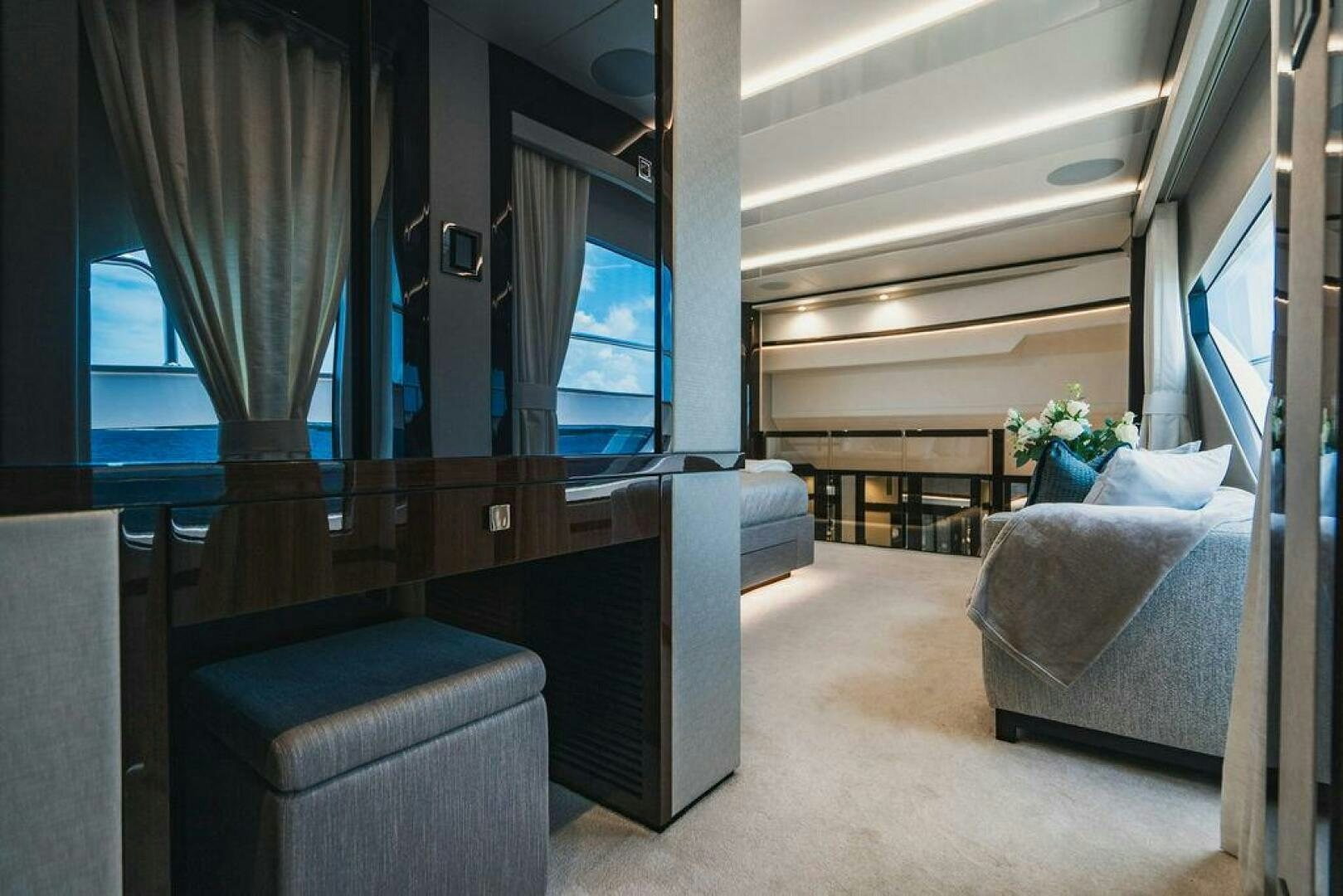 a room with a bed and desk aboard PURA VIDA Yacht for Sale