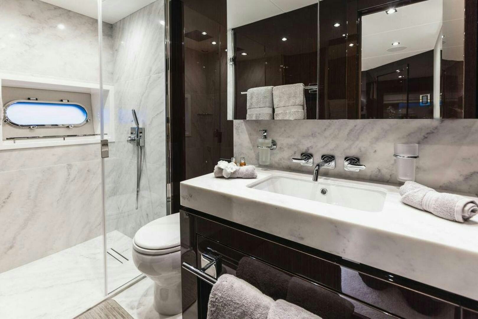 a bathroom with a sink and a toilet aboard PURA VIDA Yacht for Sale