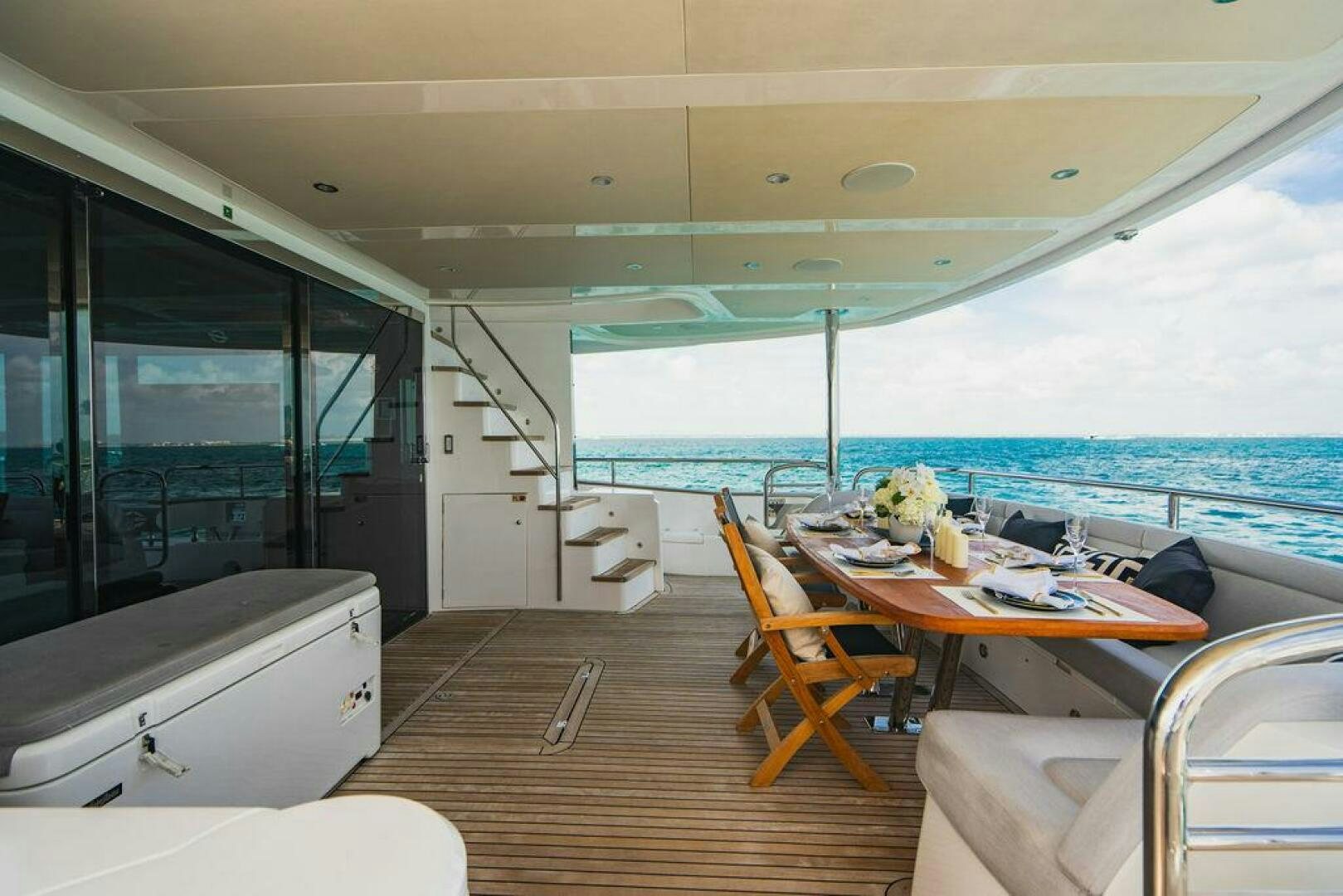 a large open space with a large balcony overlooking the ocean aboard PURA VIDA Yacht for Sale