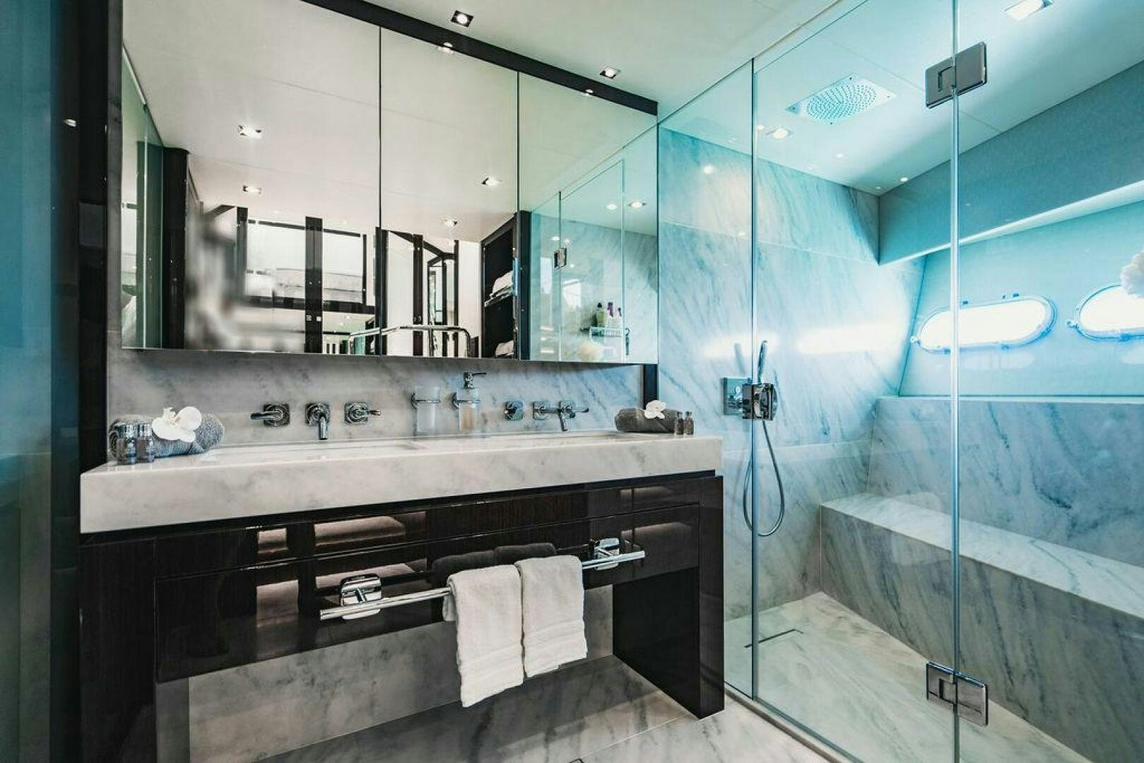 a bathroom with a large mirror aboard PURA VIDA Yacht for Sale