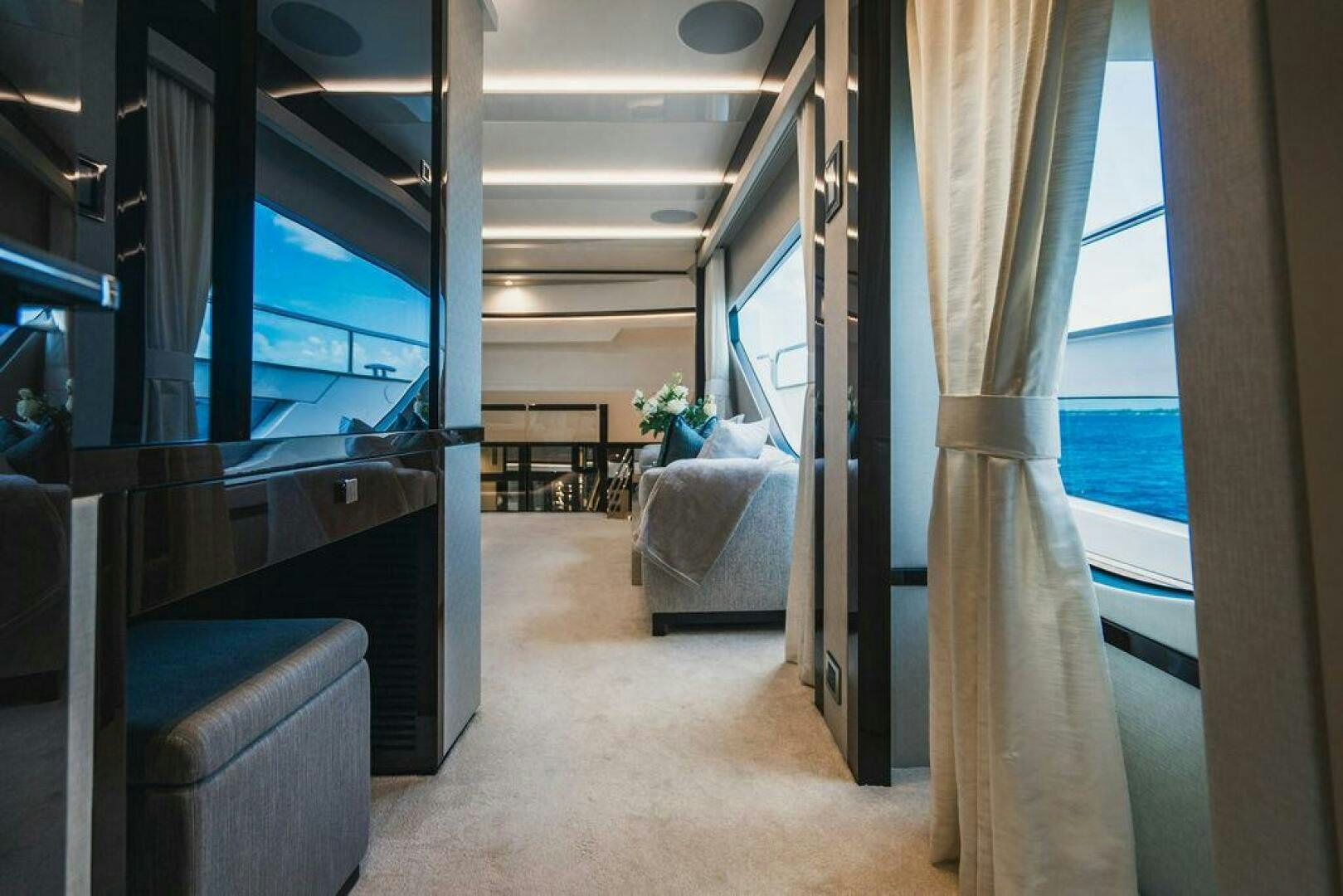 a room with a bed and a chair aboard PURA VIDA Yacht for Sale
