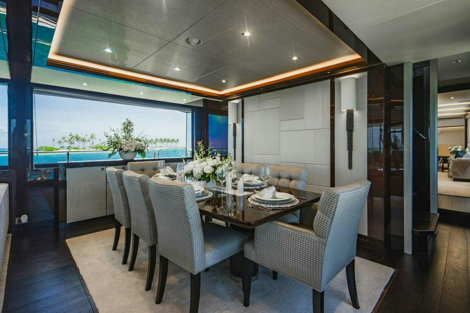 a dining room with a table and chairs aboard PURA VIDA Yacht for Sale