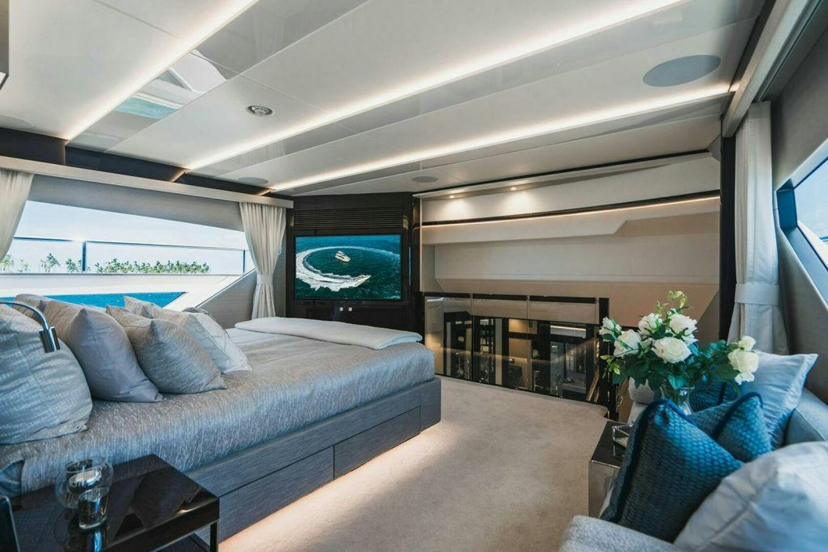 a living room with a large screen aboard PURA VIDA Yacht for Sale