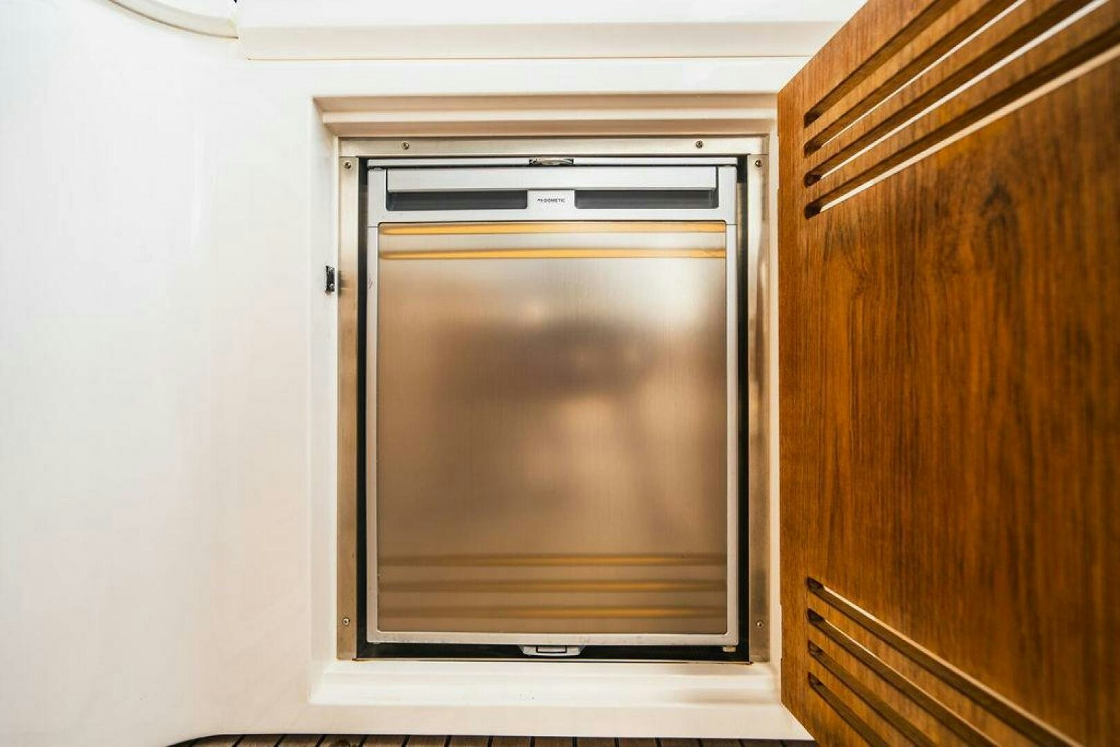 a white wall with a television on it aboard PURA VIDA Yacht for Sale