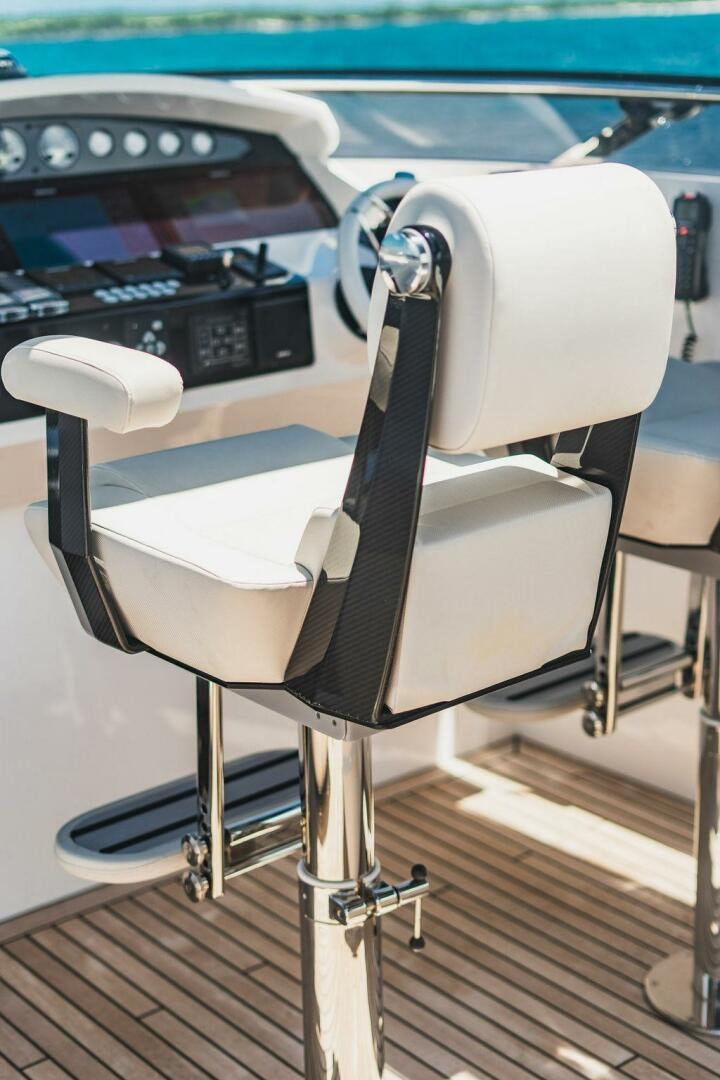 a white chair in front of a car aboard PURA VIDA Yacht for Sale
