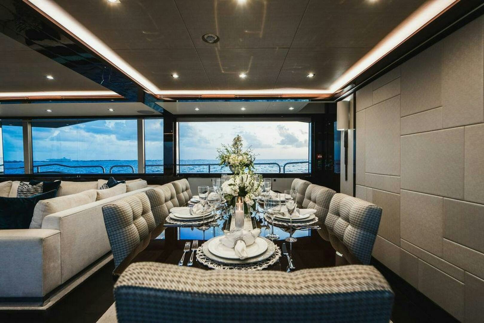 a living room with a large window aboard PURA VIDA Yacht for Sale