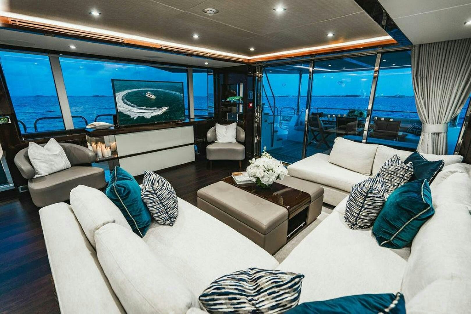 a living room with a large window aboard PURA VIDA Yacht for Sale