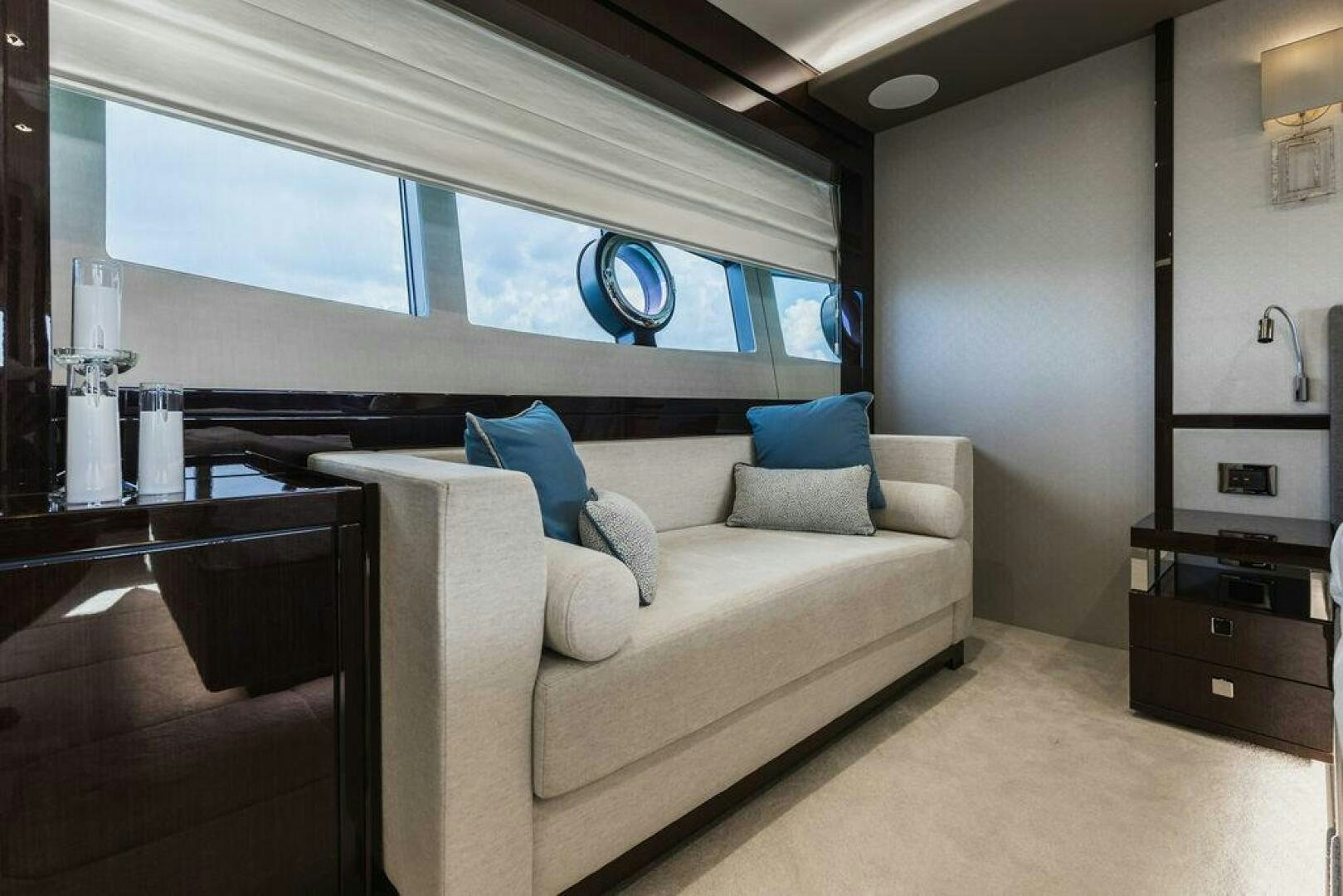a room with a couch and a window aboard PURA VIDA Yacht for Sale