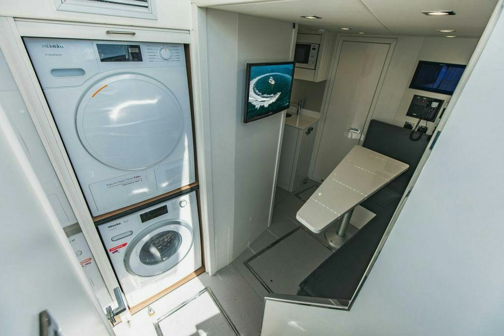 a washing machine in a room aboard PURA VIDA Yacht for Sale