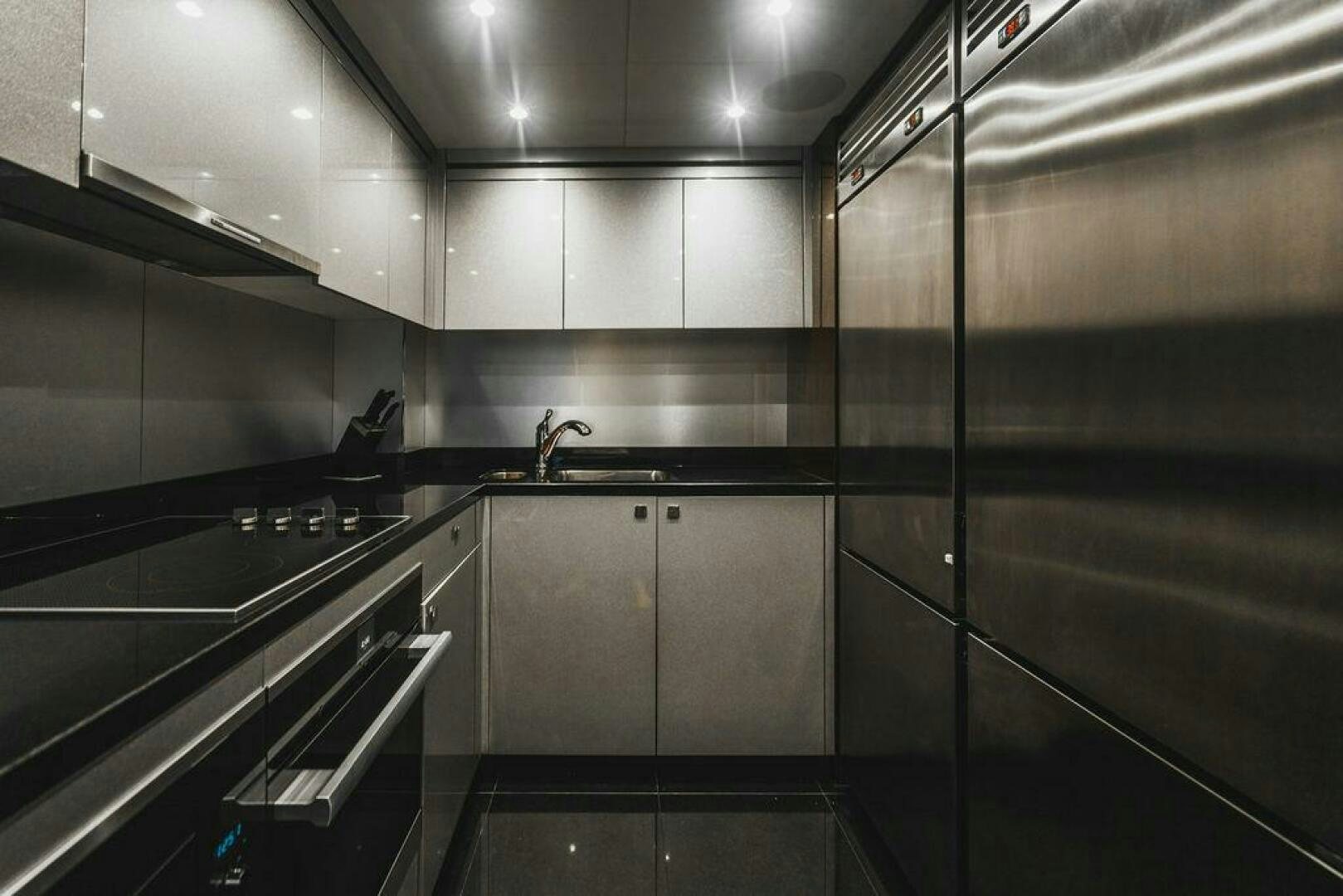 a kitchen with stainless steel appliances aboard PURA VIDA Yacht for Sale