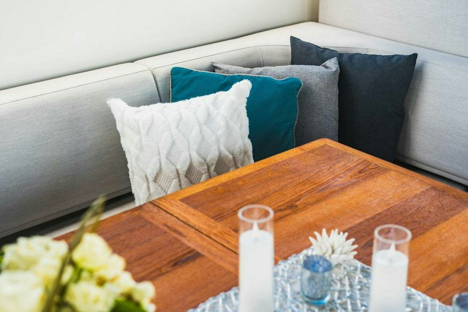 a table with a candle and a vase of flowers on it aboard PURA VIDA Yacht for Sale