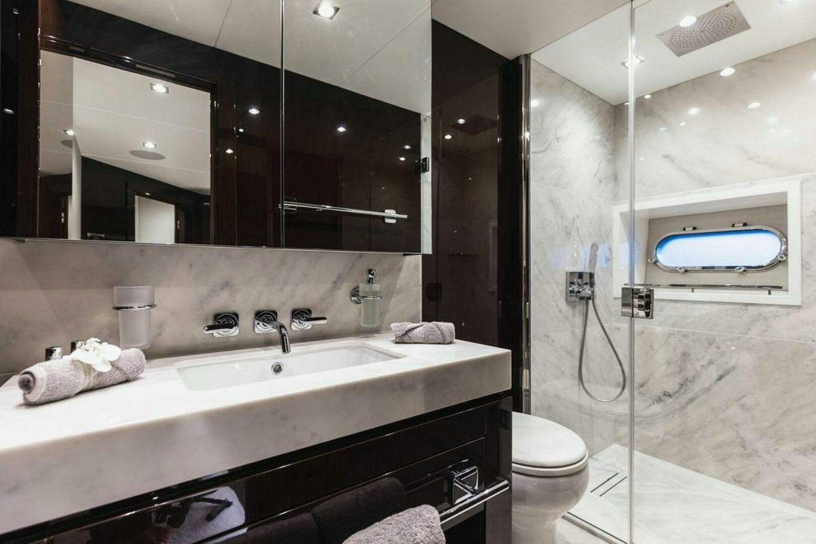 a bathroom with a sink and a toilet aboard PURA VIDA Yacht for Sale