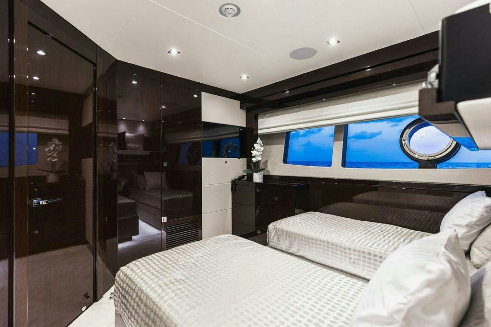 a room with a bed and a tv aboard PURA VIDA Yacht for Sale