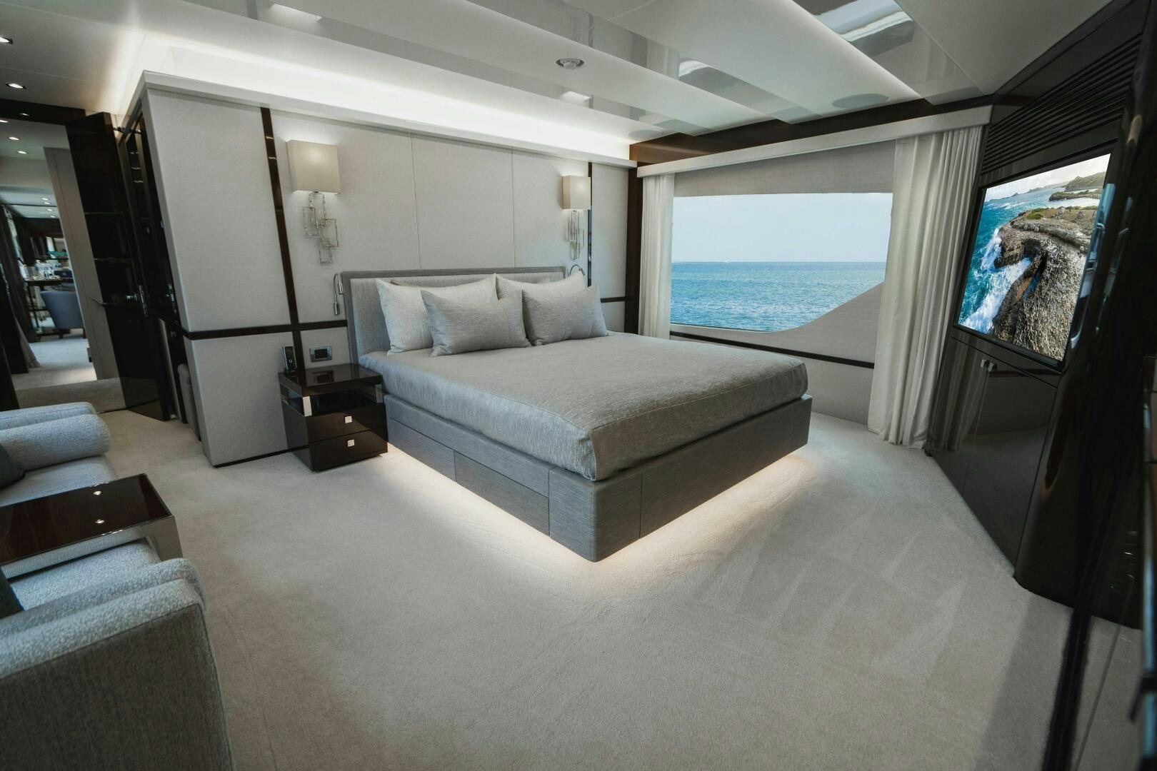 a large white bedroom with a large window and a large body of water aboard PURA VIDA Yacht for Sale