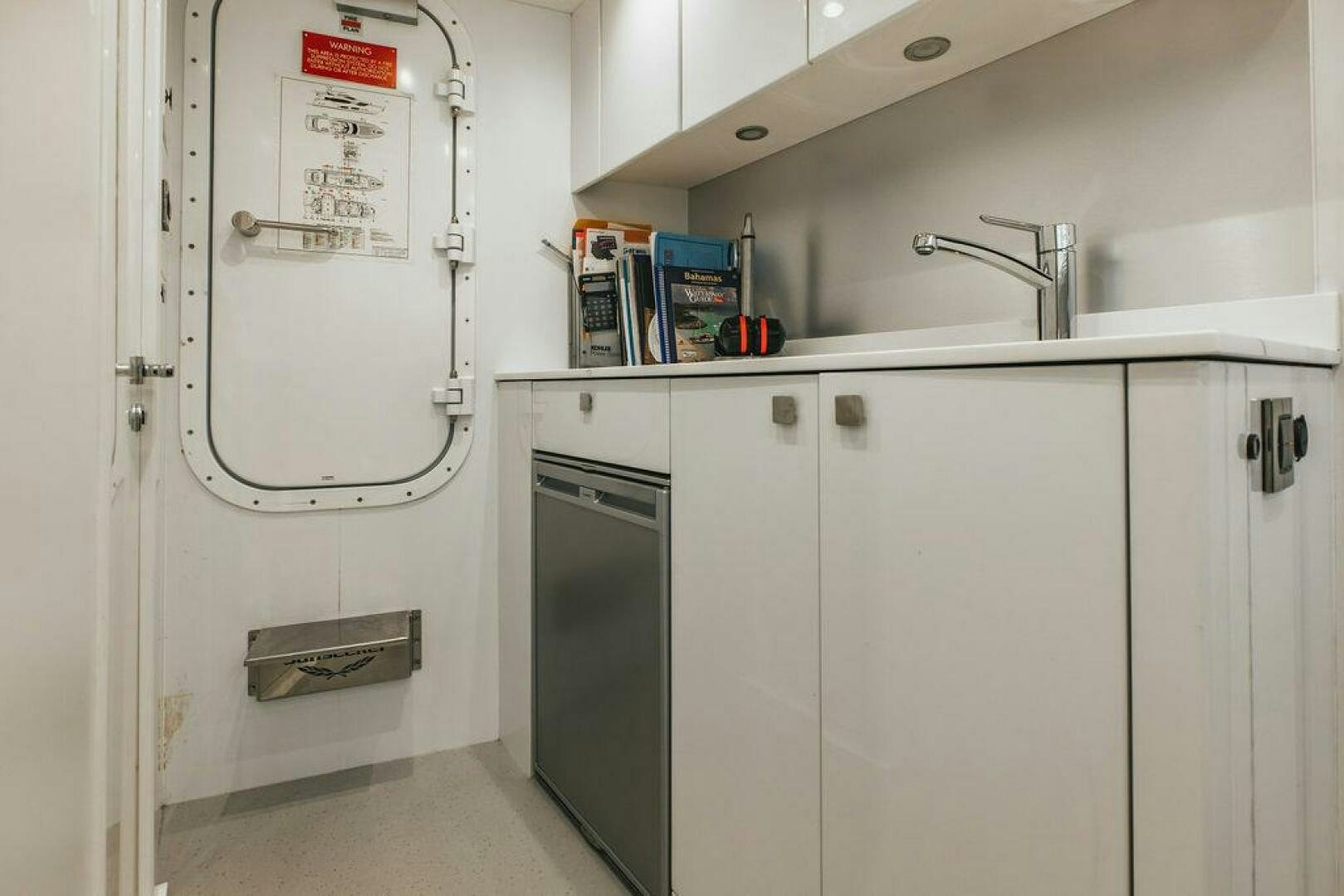 a white refrigerator in a kitchen aboard PURA VIDA Yacht for Sale