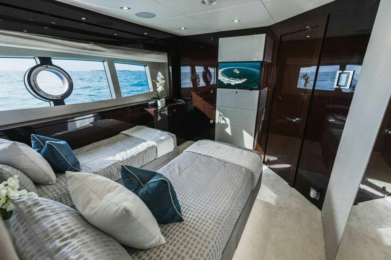 a room with a bed and a window aboard PURA VIDA Yacht for Sale