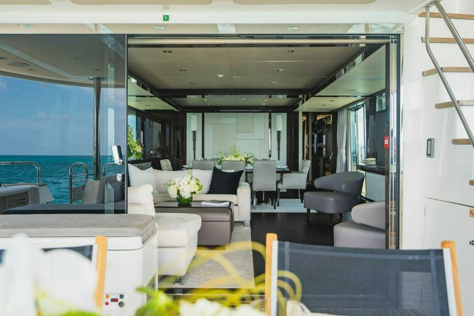 a room with a couch and chairs aboard PURA VIDA Yacht for Sale