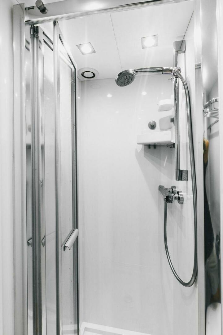 a shower with a glass door aboard PURA VIDA Yacht for Sale