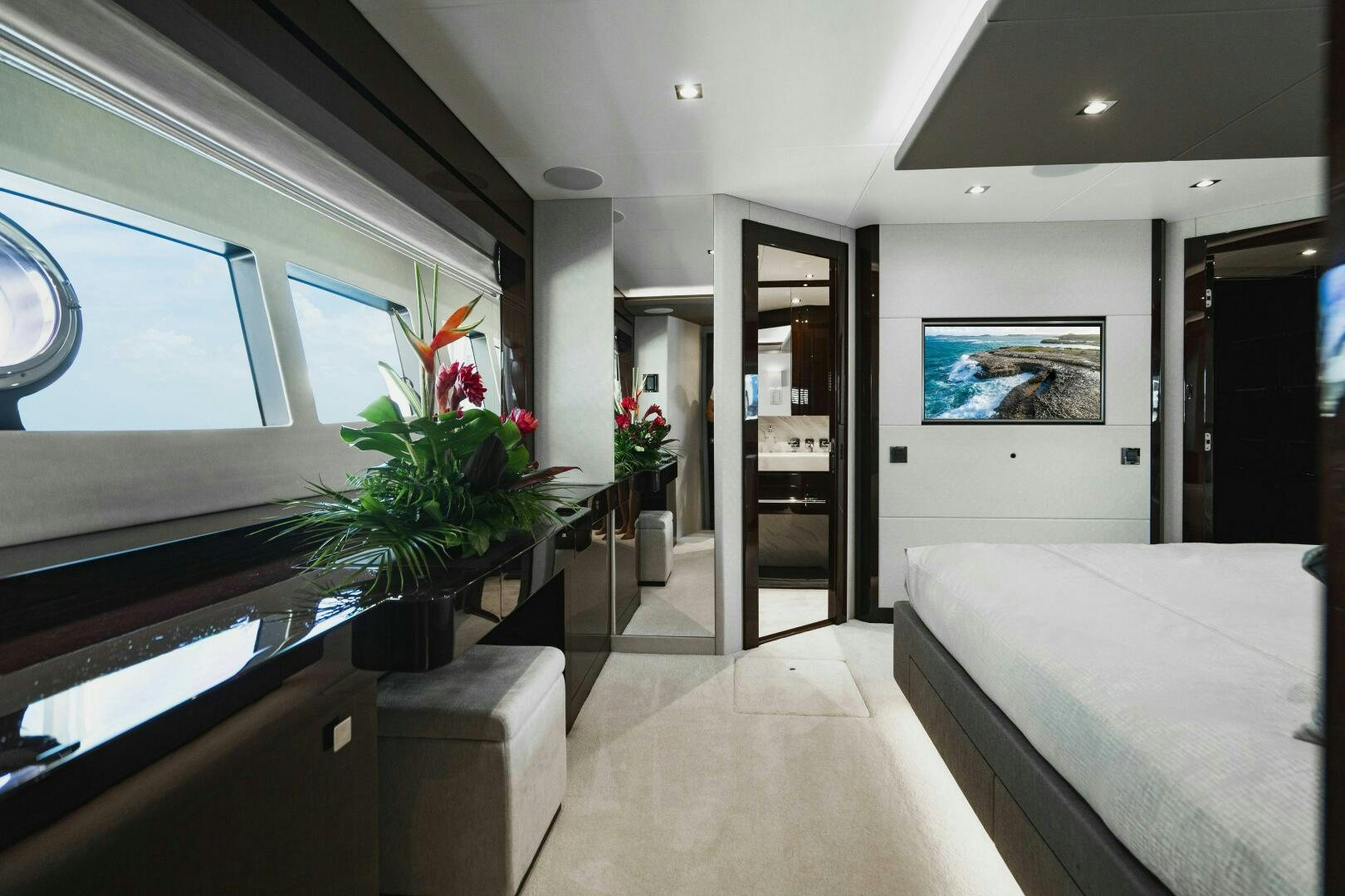 a room with a bed and a plant in it aboard PURA VIDA Yacht for Sale