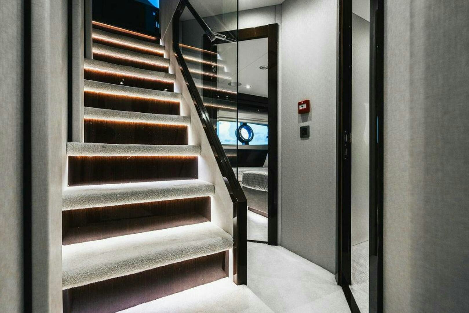a staircase with a glass door aboard PURA VIDA Yacht for Sale