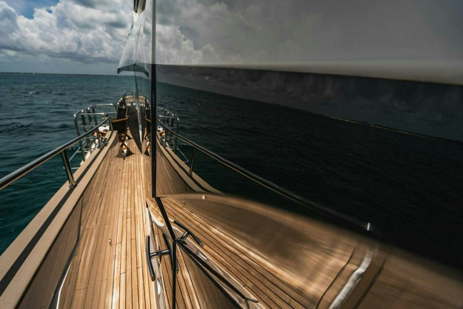a wooden dock over the ocean aboard PURA VIDA Yacht for Sale