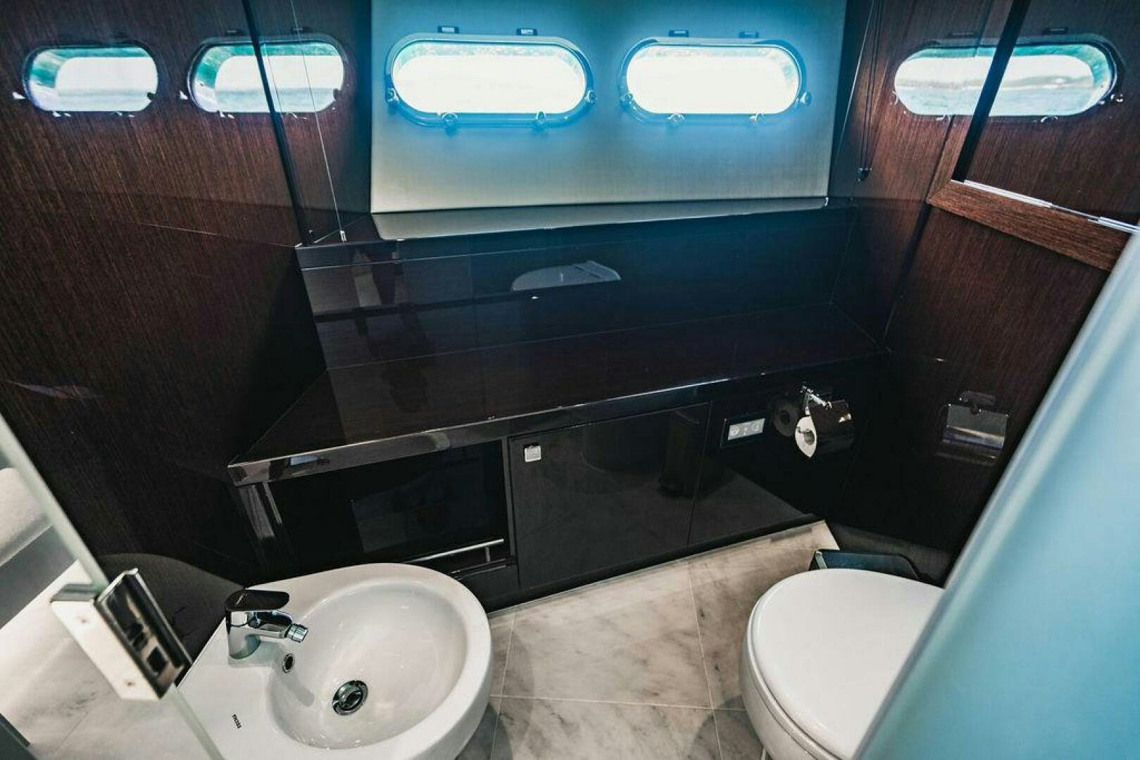 a bathroom with a sink and toilet aboard PURA VIDA Yacht for Sale