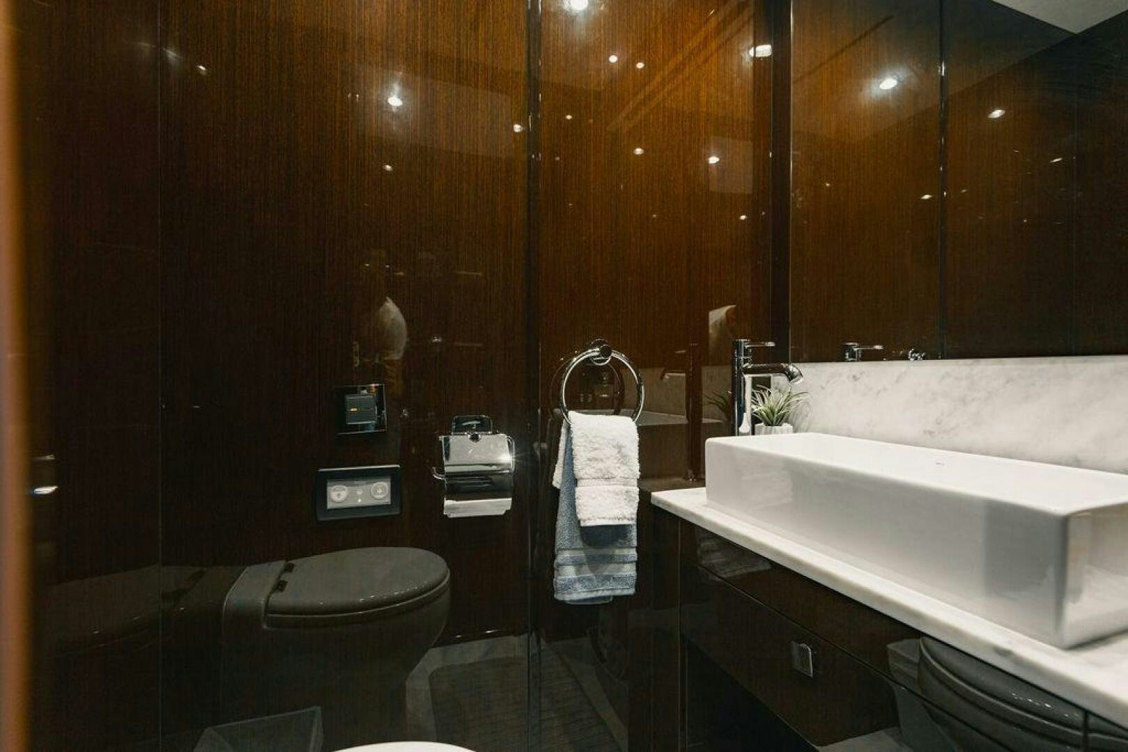 a bathroom with a tub sink and toilet aboard PURA VIDA Yacht for Sale