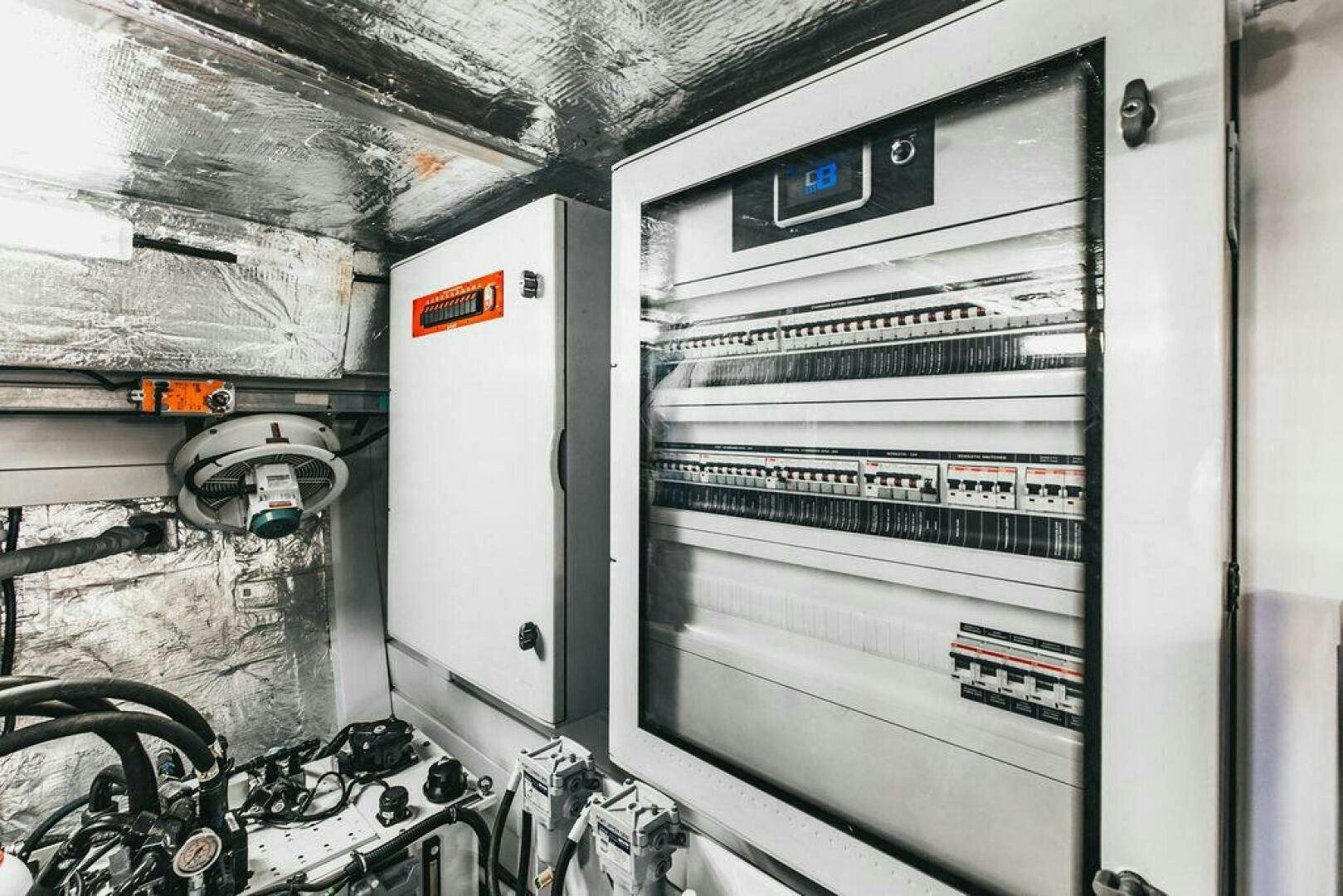 a room with a computer and equipment aboard PURA VIDA Yacht for Sale