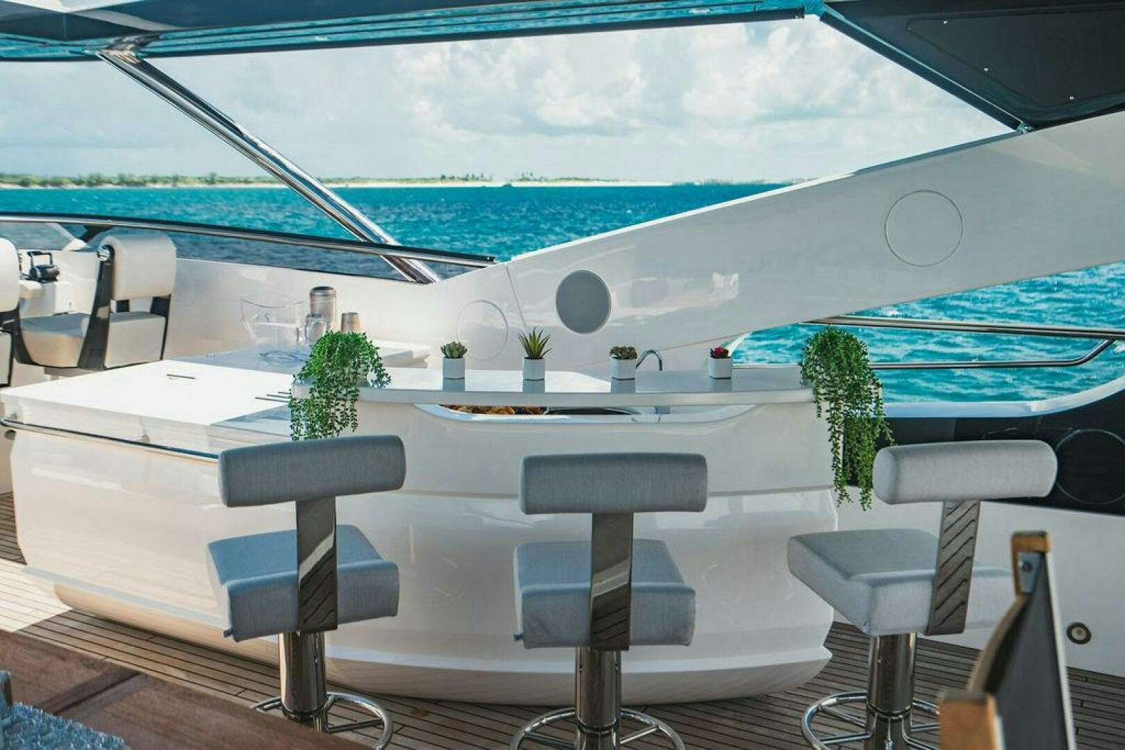 a white table with chairs on it aboard PURA VIDA Yacht for Sale