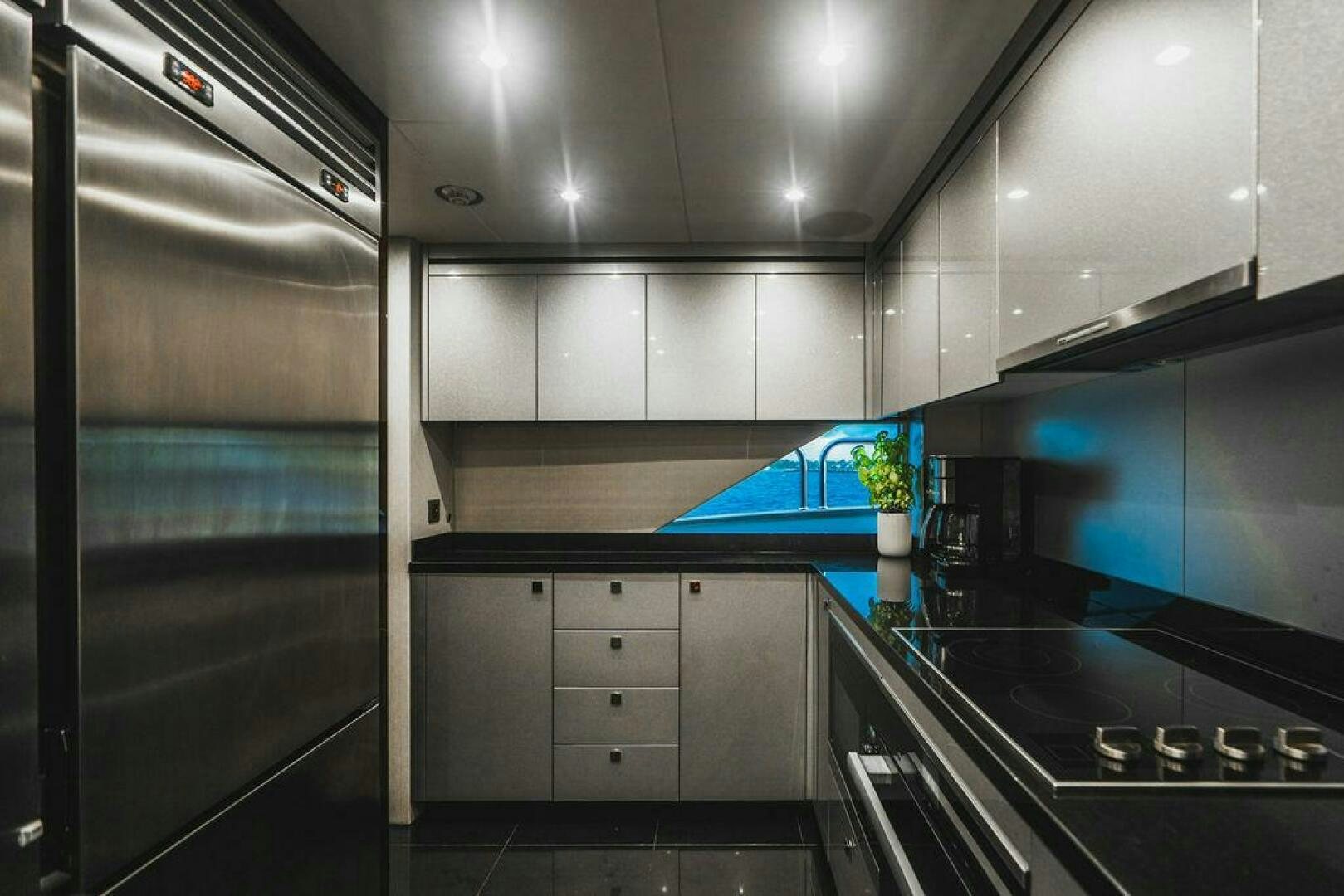 a kitchen with a refrigerator and stove aboard PURA VIDA Yacht for Sale