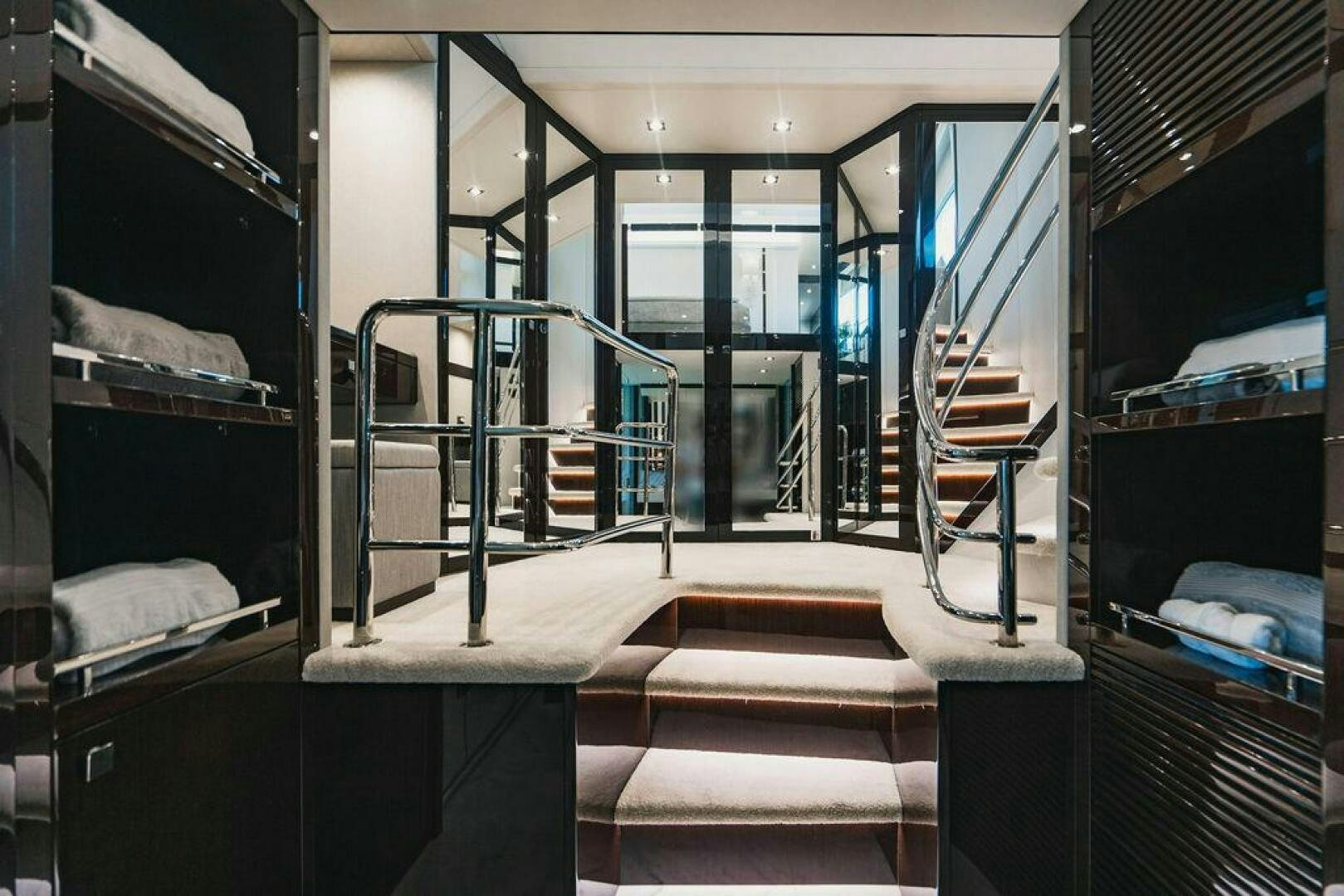 a room with a staircase and glass doors aboard PURA VIDA Yacht for Sale