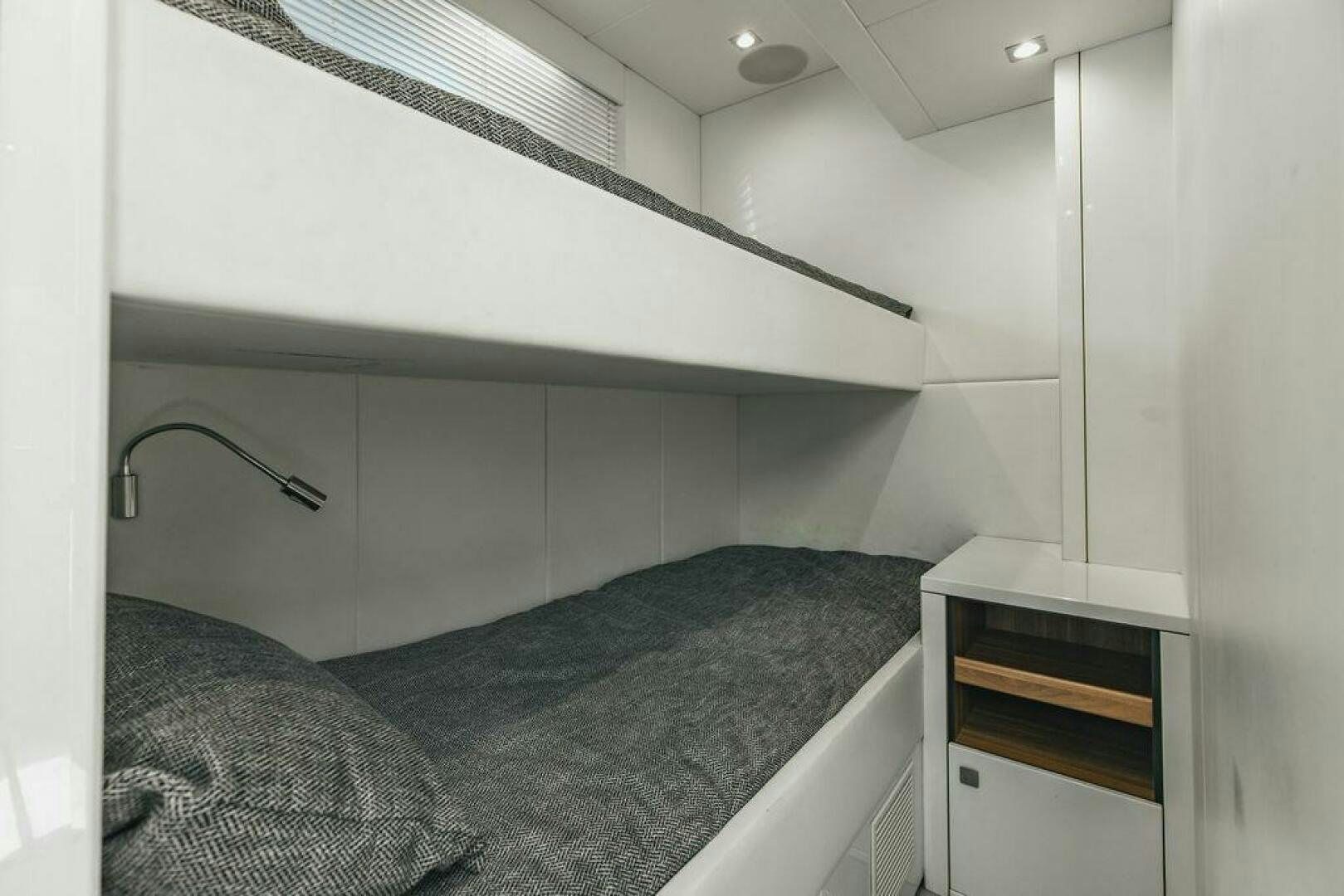 a bed with a black comforter aboard PURA VIDA Yacht for Sale