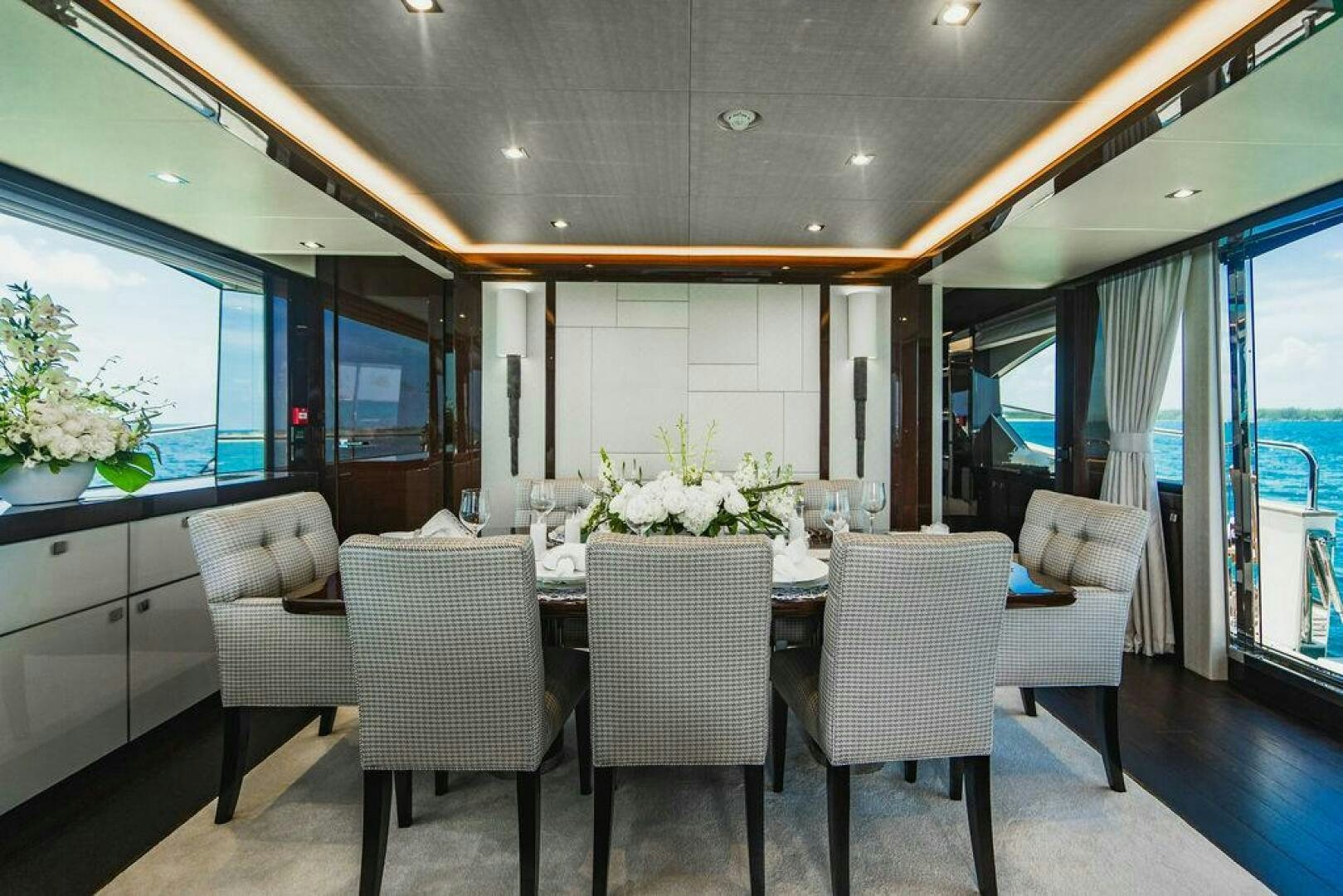 a dining room with a table and chairs aboard PURA VIDA Yacht for Sale