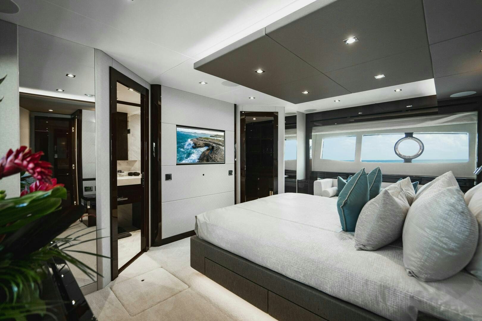 a living room with a couch and a television aboard PURA VIDA Yacht for Sale